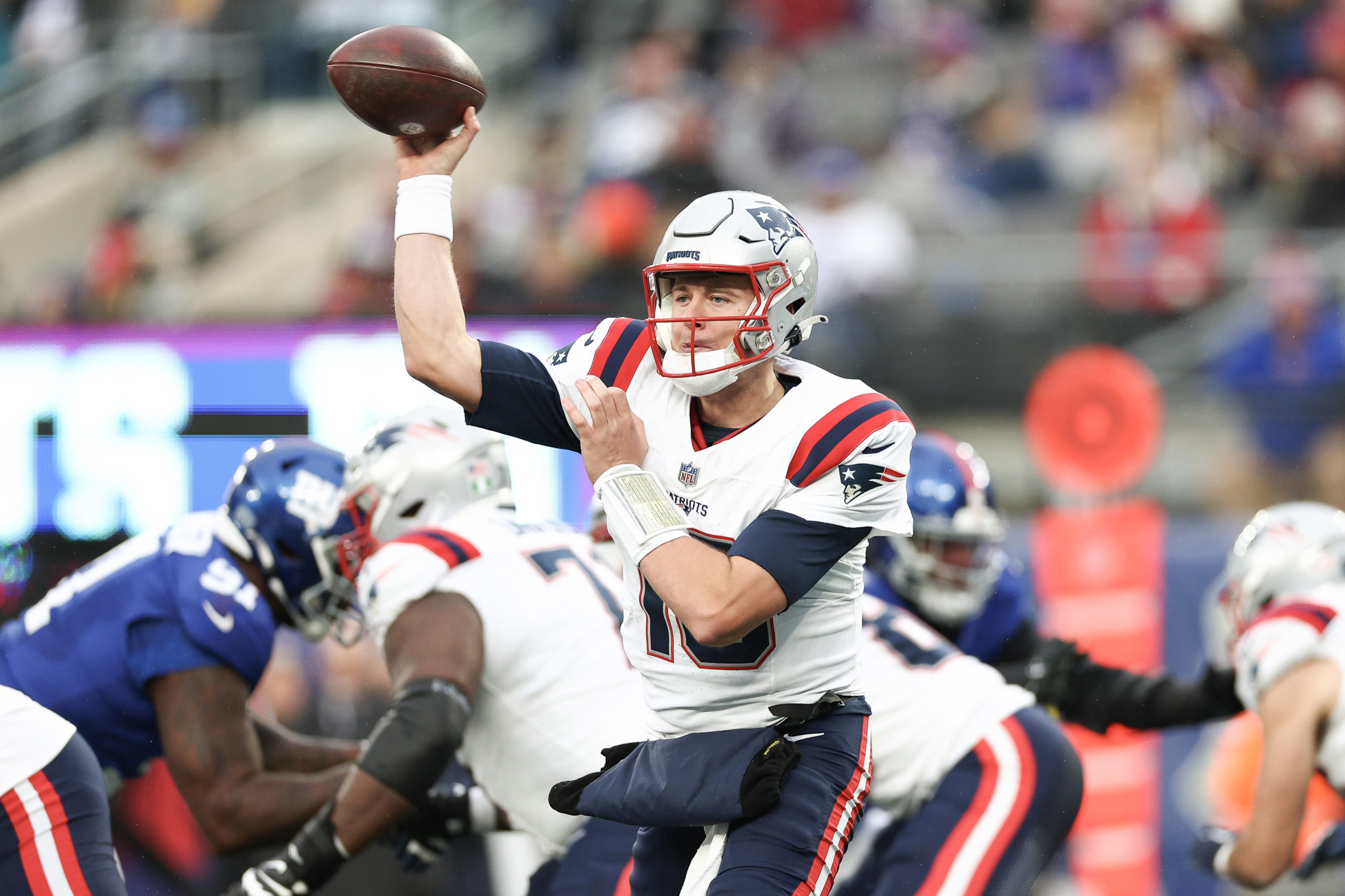 EAST RUTHERFORD, NEW JERSEY - NOVEMBER 26: Mac Jones #10 of the New England Patriots attempts a pass during the second quarter against the New York Giants at MetLife Stadium on November 26, 2023 in East Rutherford, New Jersey. Elsa/Getty Images