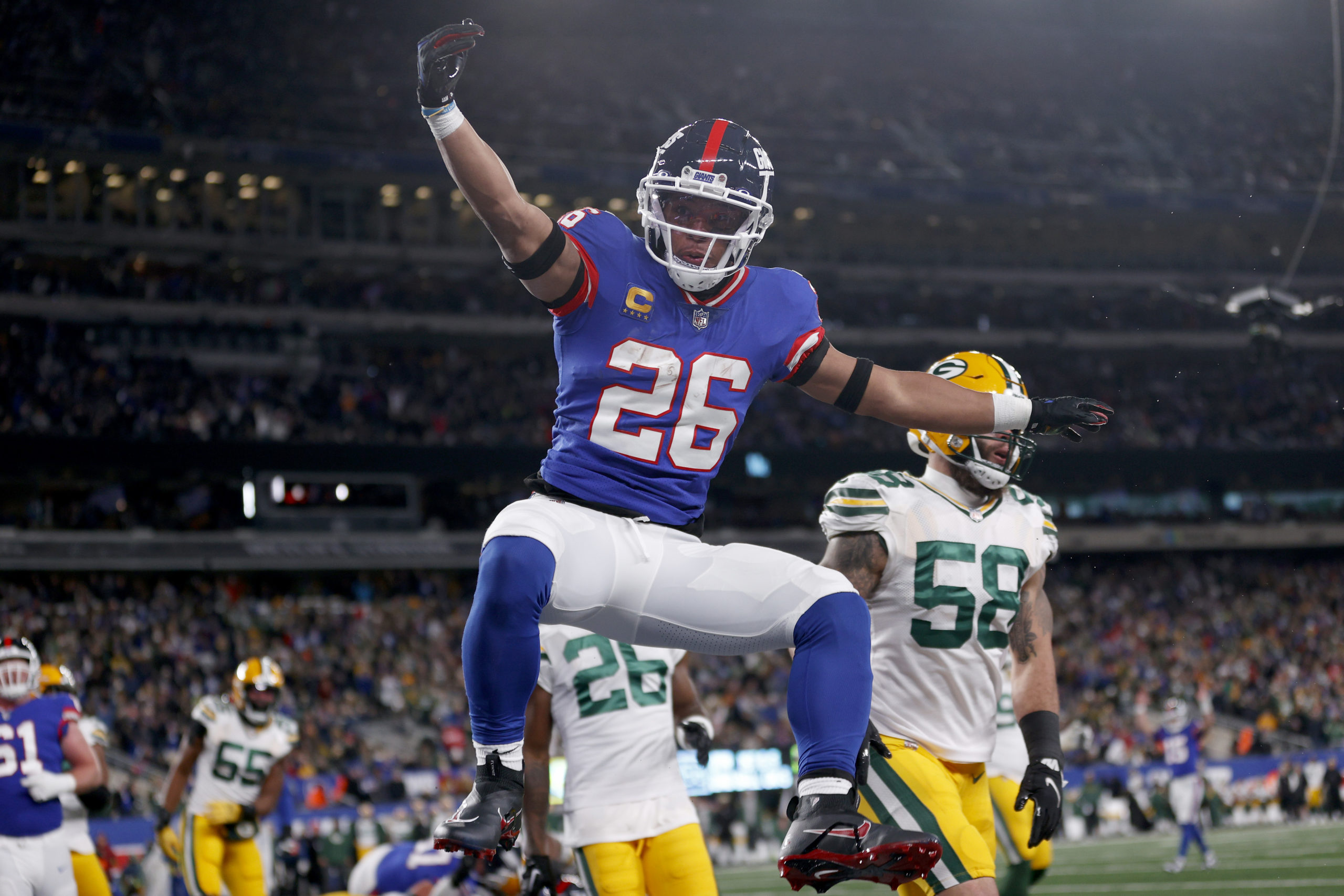 EAST RUTHERFORD, NEW JERSEY - DECEMBER 11: Saquon Barkley #26 of the New York Giants celebrates after scoring a five yard touchdown against the Green Bay Packers during the second quarter in the game at MetLife Stadium on December 11, 2023 in East Rutherford, New Jersey. Sarah Stier/Getty Images