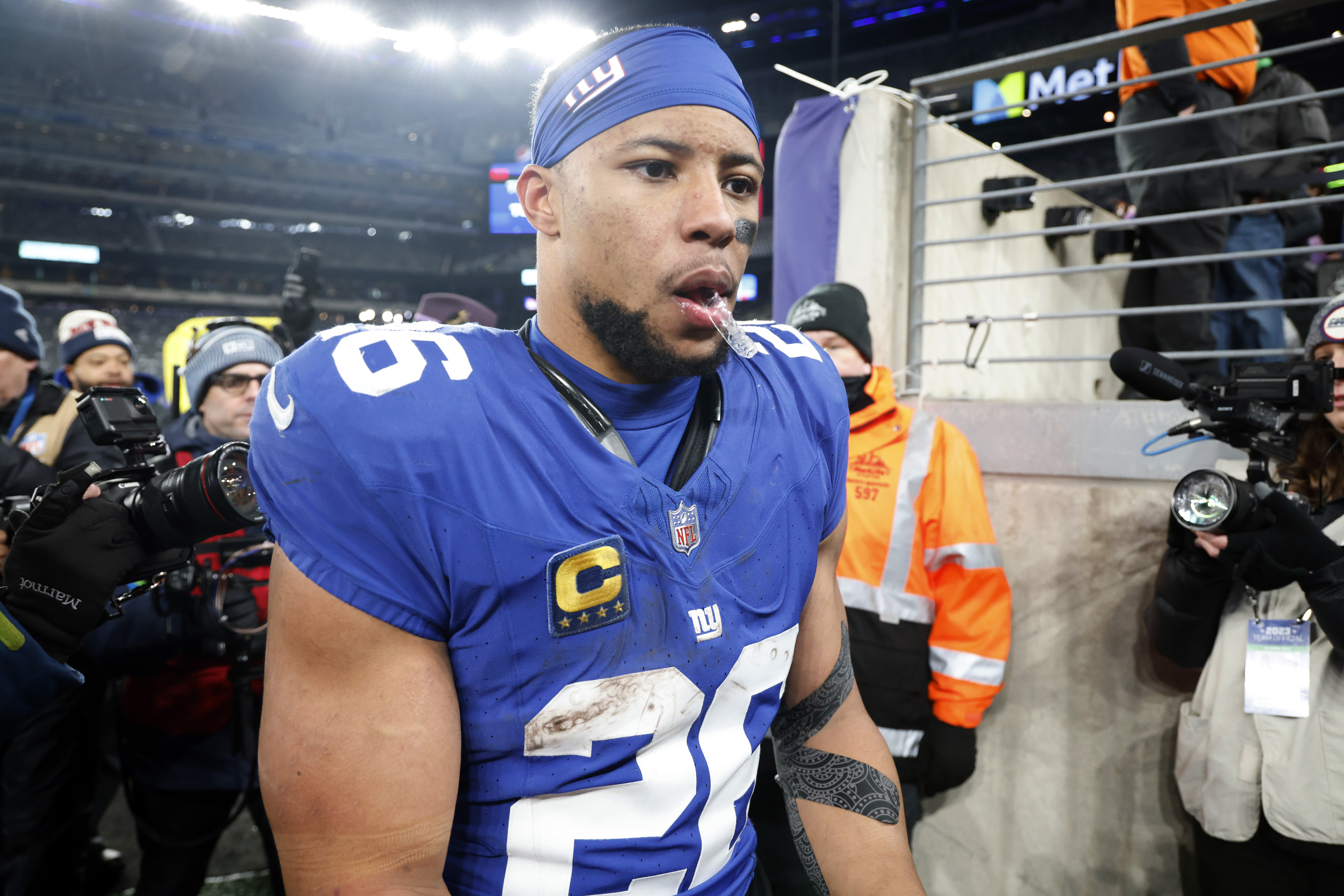 EAST RUTHERFORD, NEW JERSEY - JANUARY 07: Saquon Barkley #26 of the New York Giants walks off the field after a win over the Philadelphia Eagles at MetLife Stadium on January 07, 2024 in East Rutherford, New Jersey. Al Bello/Getty Images