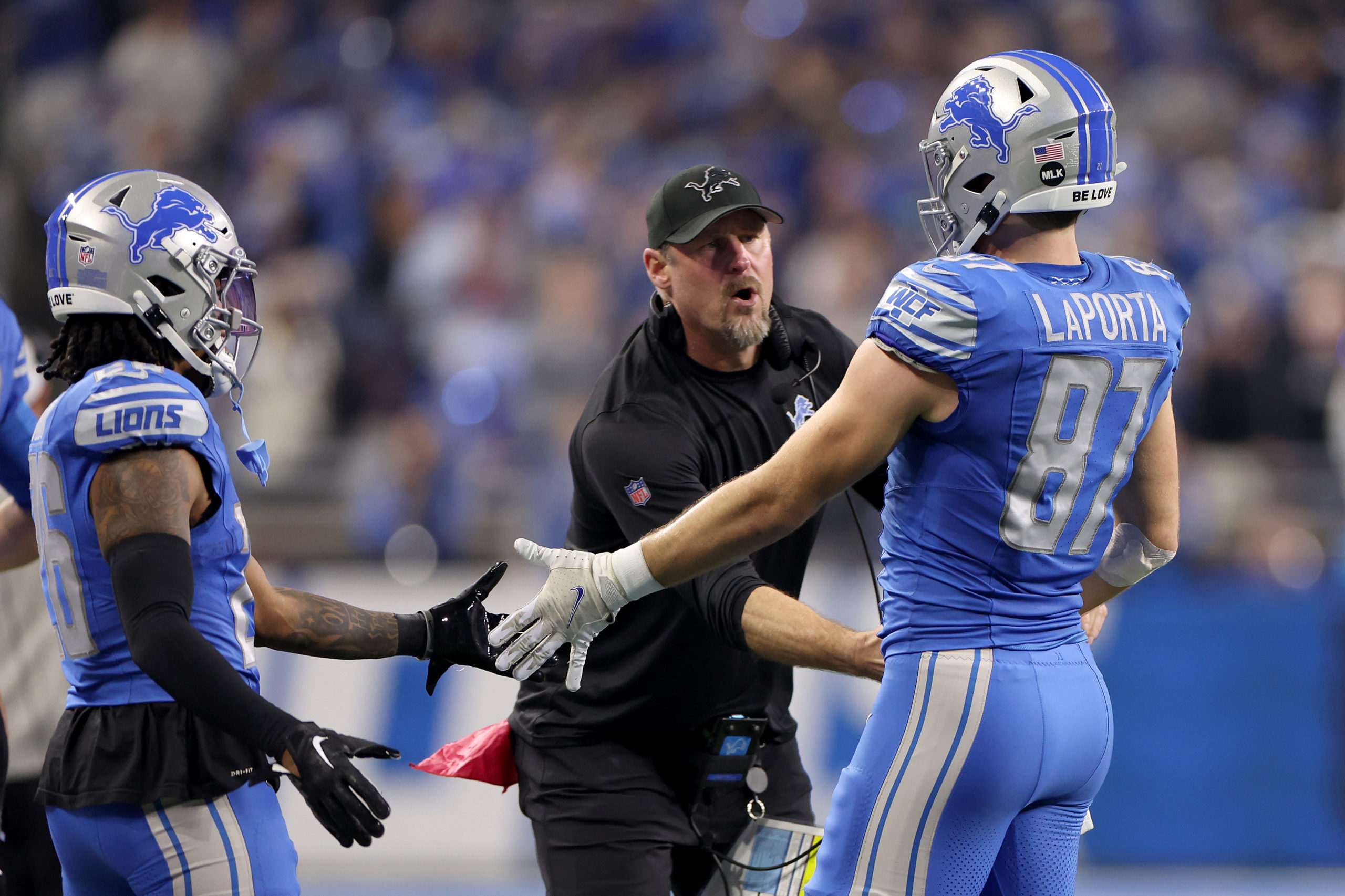 DETROIT, MICHIGAN - JANUARY 14: Head coach Dan Campbell of the Detroit Lions reacts with Sam LaPorta #87 during the second quarter against the Los Angeles Rams in the NFC Wild Card Playoffs at Ford Field on January 14, 2024 in Detroit, Michigan. Gregory Shamus/Getty Images