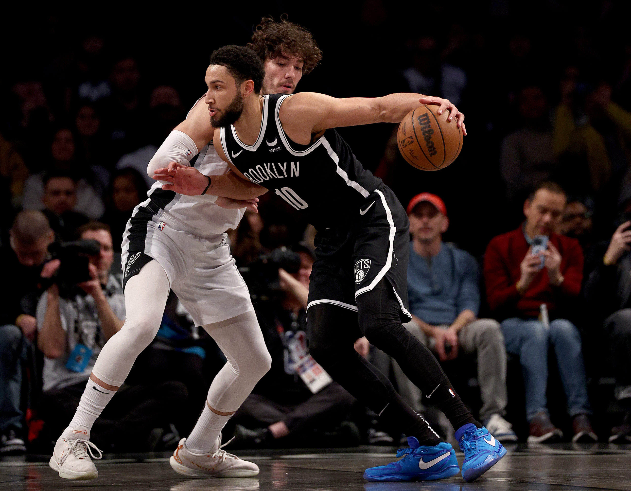 NEW YORK, NEW YORK - FEBRUARY 10: Ben Simmons #10 of the Brooklyn Nets heads for the net as Cedi Osman #16 of the San Antonio Spurs defendsin the first half at Barclays Center on February 10, 2024 in the Brooklyn borough of New York City. Elsa/Getty Images