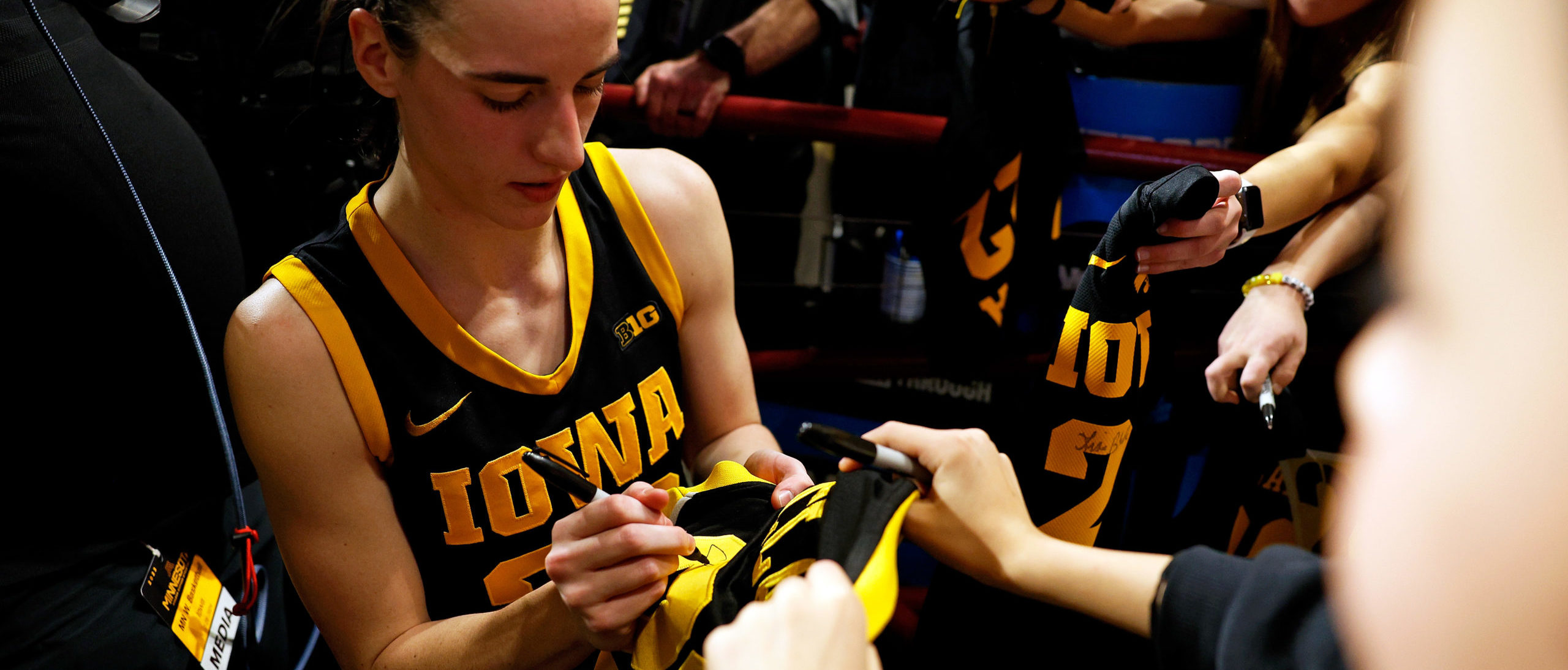 Caitlin Clark #22 of the Iowa Hawkeyes signs autographs for fans after the game against the Minnesota Golden Gophers at Williams Arena on February 28, 2024 in Minneapolis, Minnesota. The Hawkeyes defeated the Golden Gophers 108-60. (Photo by David Berding/Getty Images)