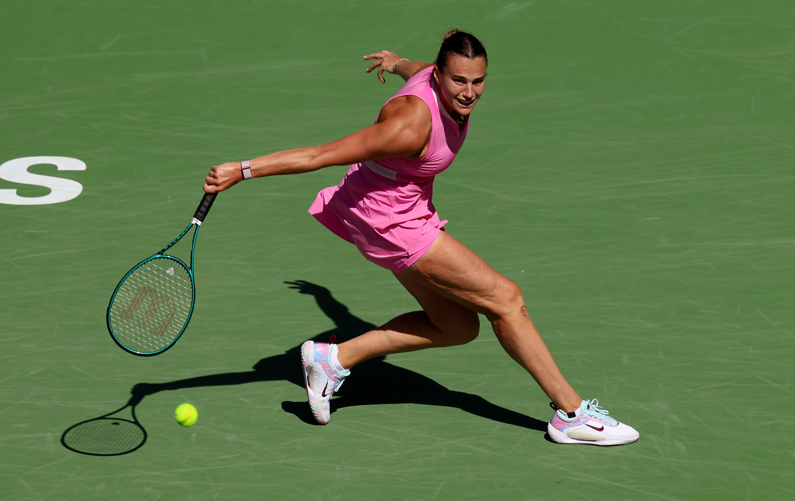 INDIAN WELLS, CALIFORNIA - MARCH 13: Aryna Sabalenka plays a backhand against Emma Navarro of the United States in their fourth round match during the BNP Paribas Open at Indian Wells Tennis Garden on March 13, 2024 in Indian Wells, California. Clive Brunskill/Getty Images