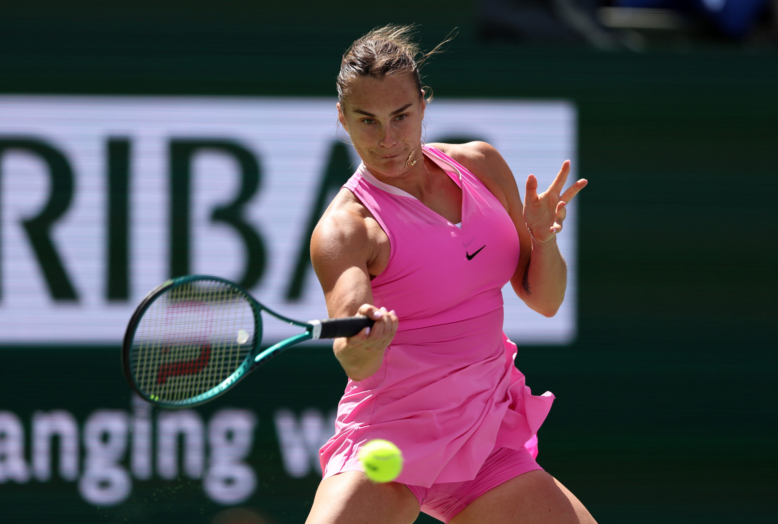 INDIAN WELLS, CALIFORNIA - MARCH 13: Aryna Sabalenka plays a forehand against Emma Navarro of the United States in their fourth round match during the BNP Paribas Open at Indian Wells Tennis Garden on March 13, 2024 in Indian Wells, California. Clive Brunskill/Getty Images