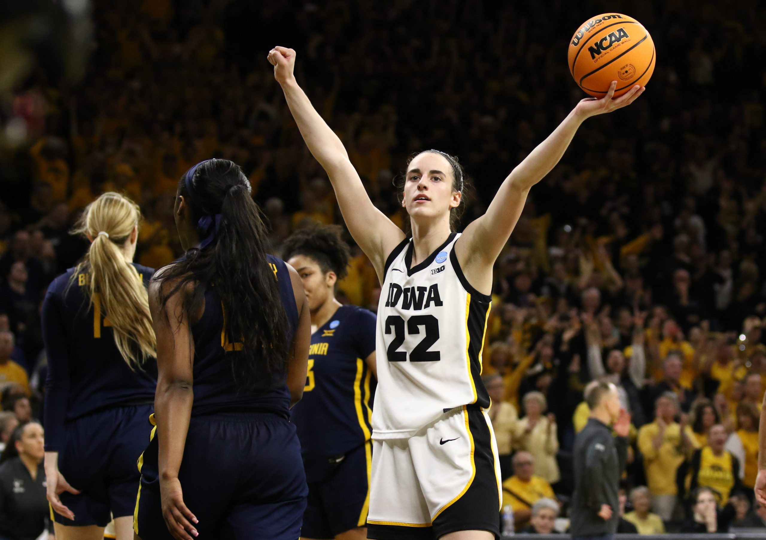 IOWA CITY, IOWA- MARCH 25: Guard Caitlin Clark #22 of the Iowa Hawkeyes celebrates as time runs out in the second half against the West Virginia Mountaineers during their second round match-up in the 2024 NCAA Division 1 Women's Basketball Championship at Carver-Hawkeye Arena on March 25, 2024 in Iowa City, Iowa. Matthew Holst/Getty Images