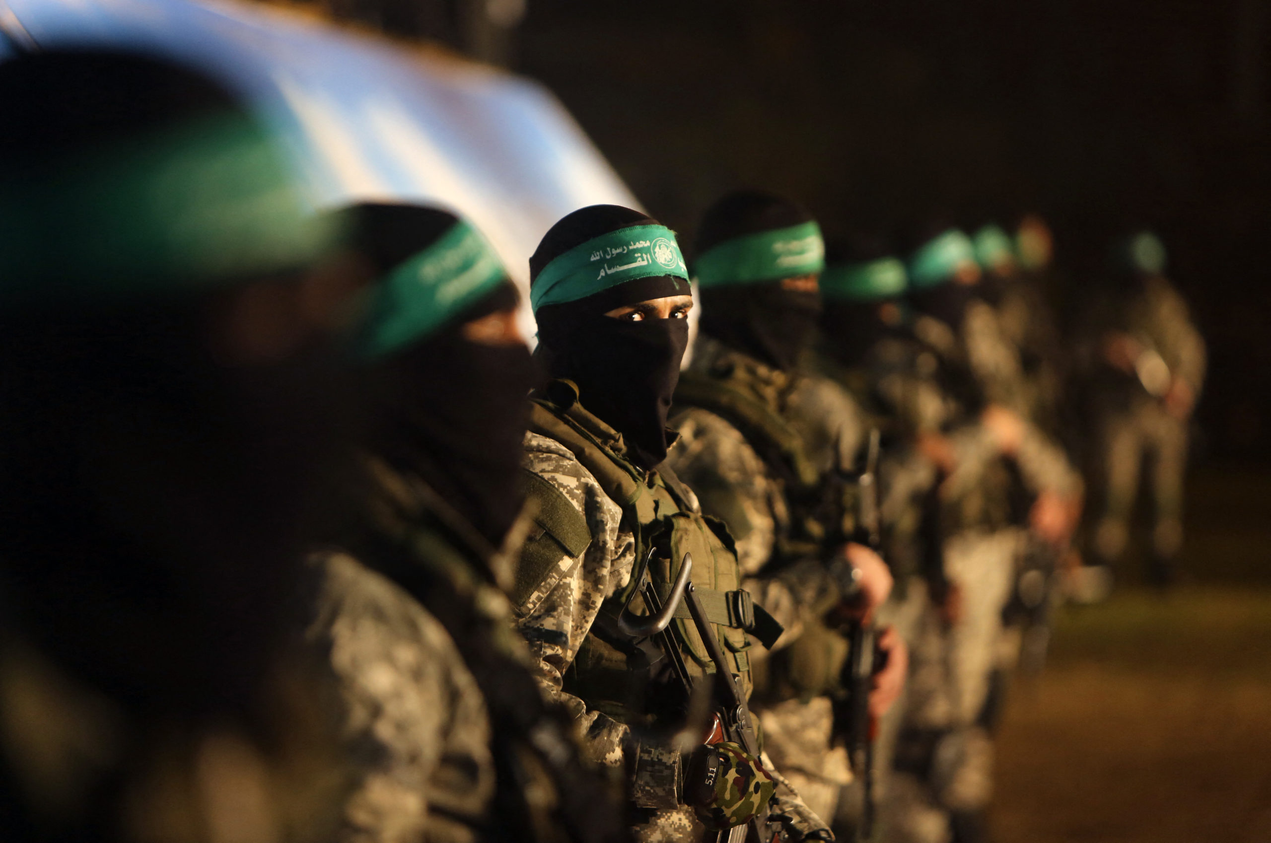 TOPSHOT - Palestinian members of the Ezzedine al-Qassam Brigades, the armed wing of the Hamas movement, take part in a gathering on January 31, 2016 in Gaza city to pay tribute to their fellow militants who died after a tunnel collapsed in the Gaza Strip. (Photo by MAHMUD HAMS/AFP via Getty Images)