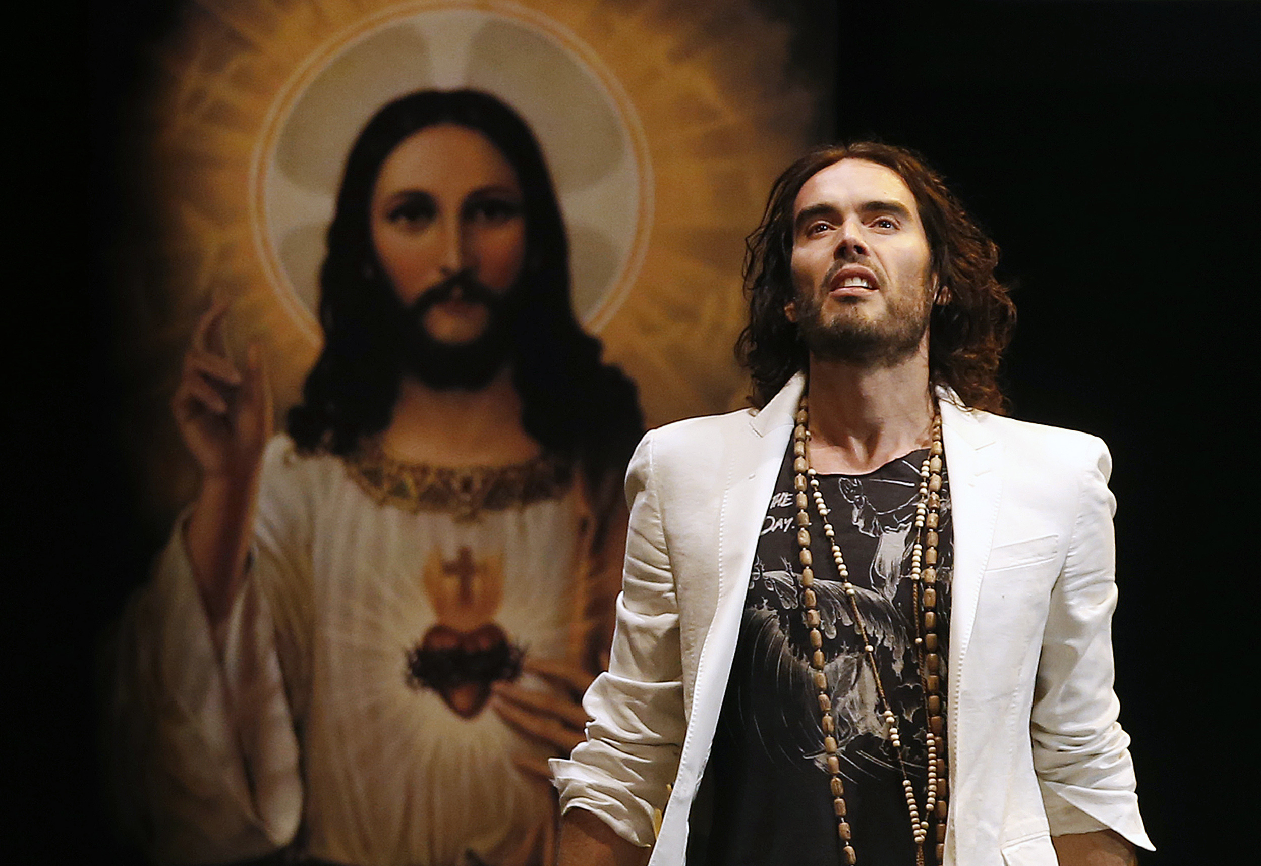 British comedian Russell Brand performs at his Messiah Complex show at Brixton Academy in London March 9, 2014. REUTERS/Olivia Harris (BRITAIN - Tags: ENTERTAINMENT)