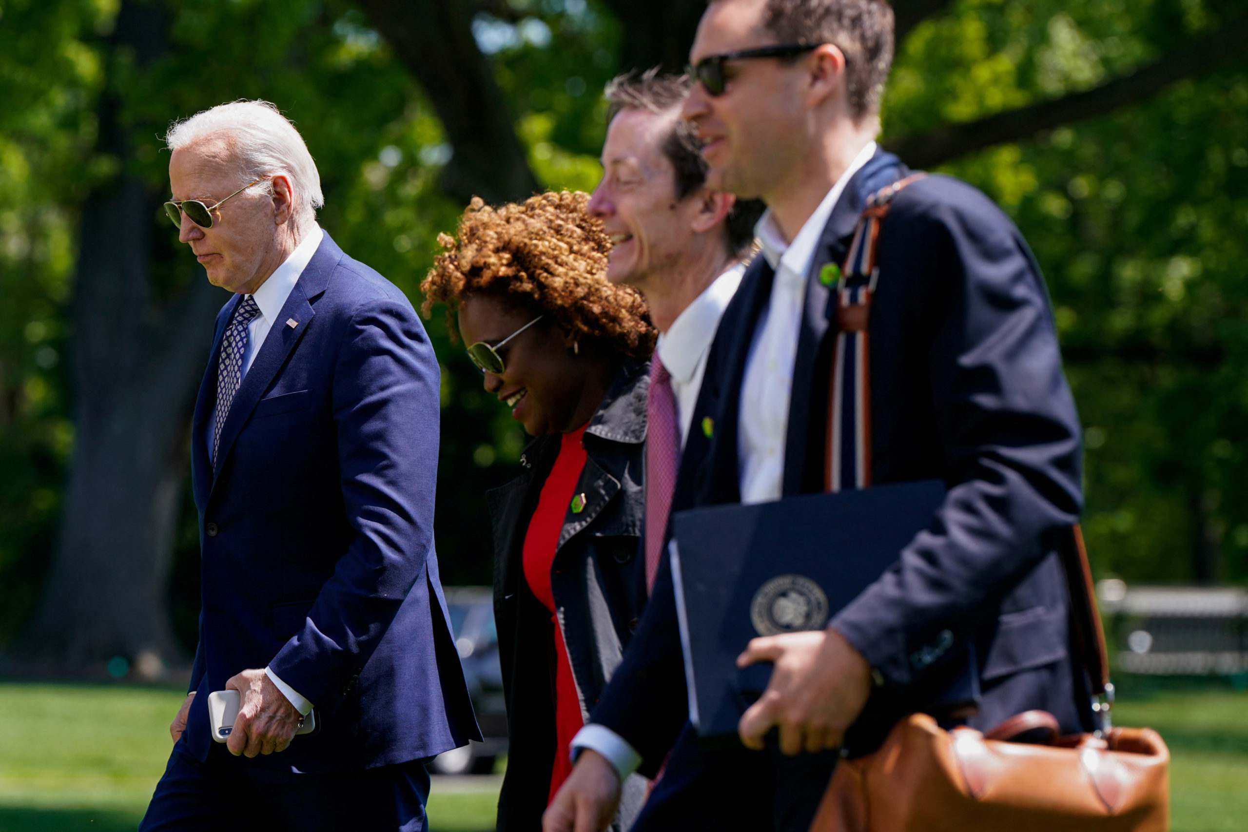 U.S. President Joe Biden walks back to the White House with staff after disembarking from Marine One, Washington, U.S., April 26, 2024. REUTERS/Elizabeth Frantz