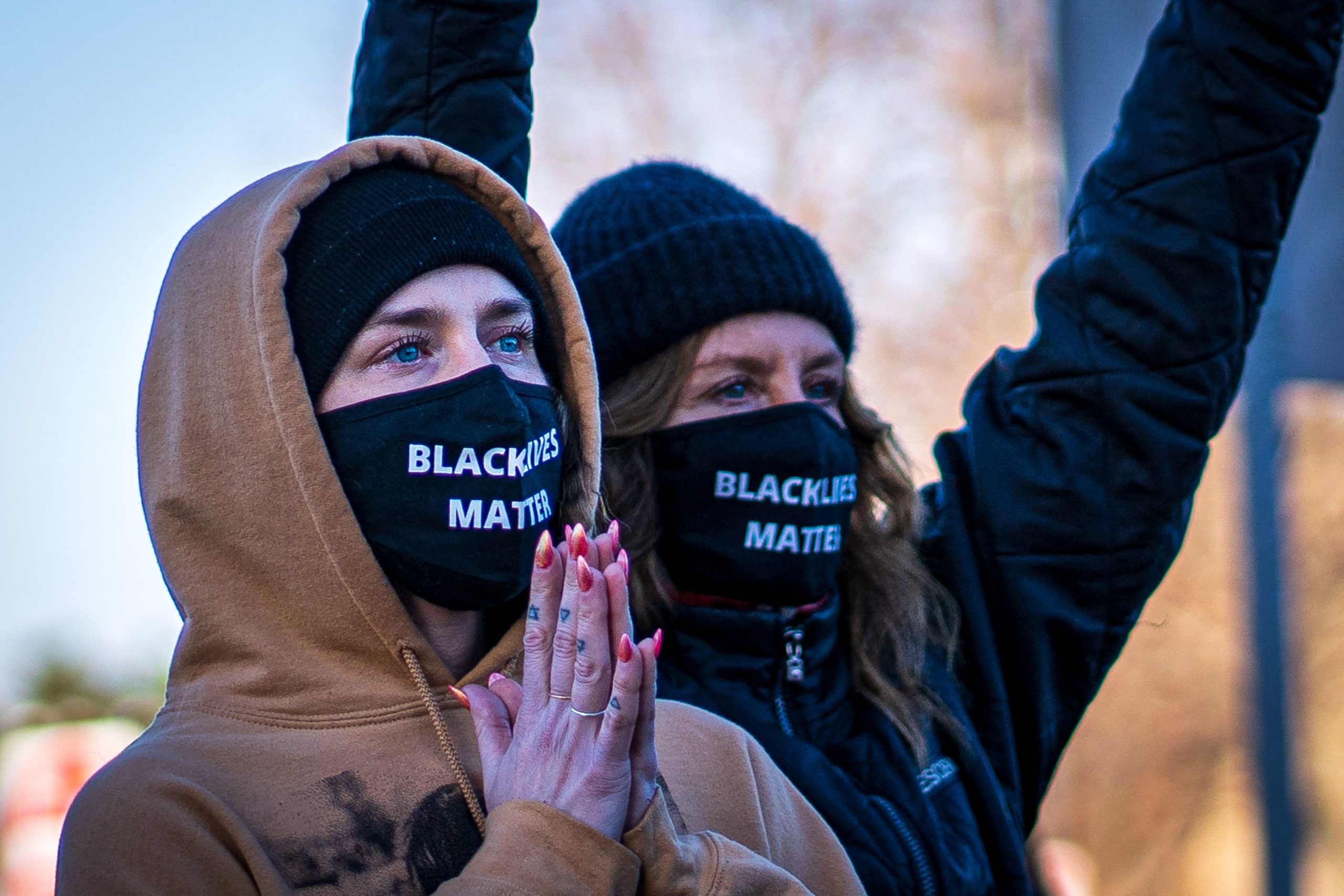 Two women wearing "Black Lives Matter" masks participate in the "Justice for George Floyd" march to the Minnesota State Capitol on March 19, 2021 in Saint Paul, Minnesota. (Photo by KEREM YUCEL/AFP via Getty Images)