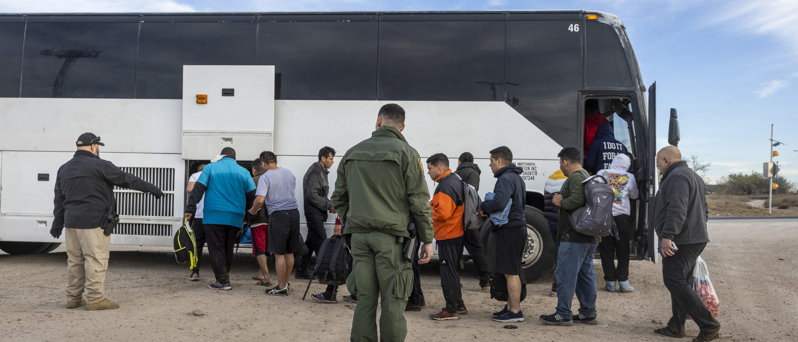 EAGLE PASS, TEXAS - JANUARY 07: Immigrants file into a U.S. Customs and Border Protection bus after crossing the U.S.-Mexico border on January 07, 2024 in Eagle Pass, Texas. According the a new report released by U.S. Department of Homeland Security, some 2.3 million migrants, mostly from families seeking asylum, have been released into the U.S. under the Biden Administration since 2021. (Photo by John Moore/Getty Images)