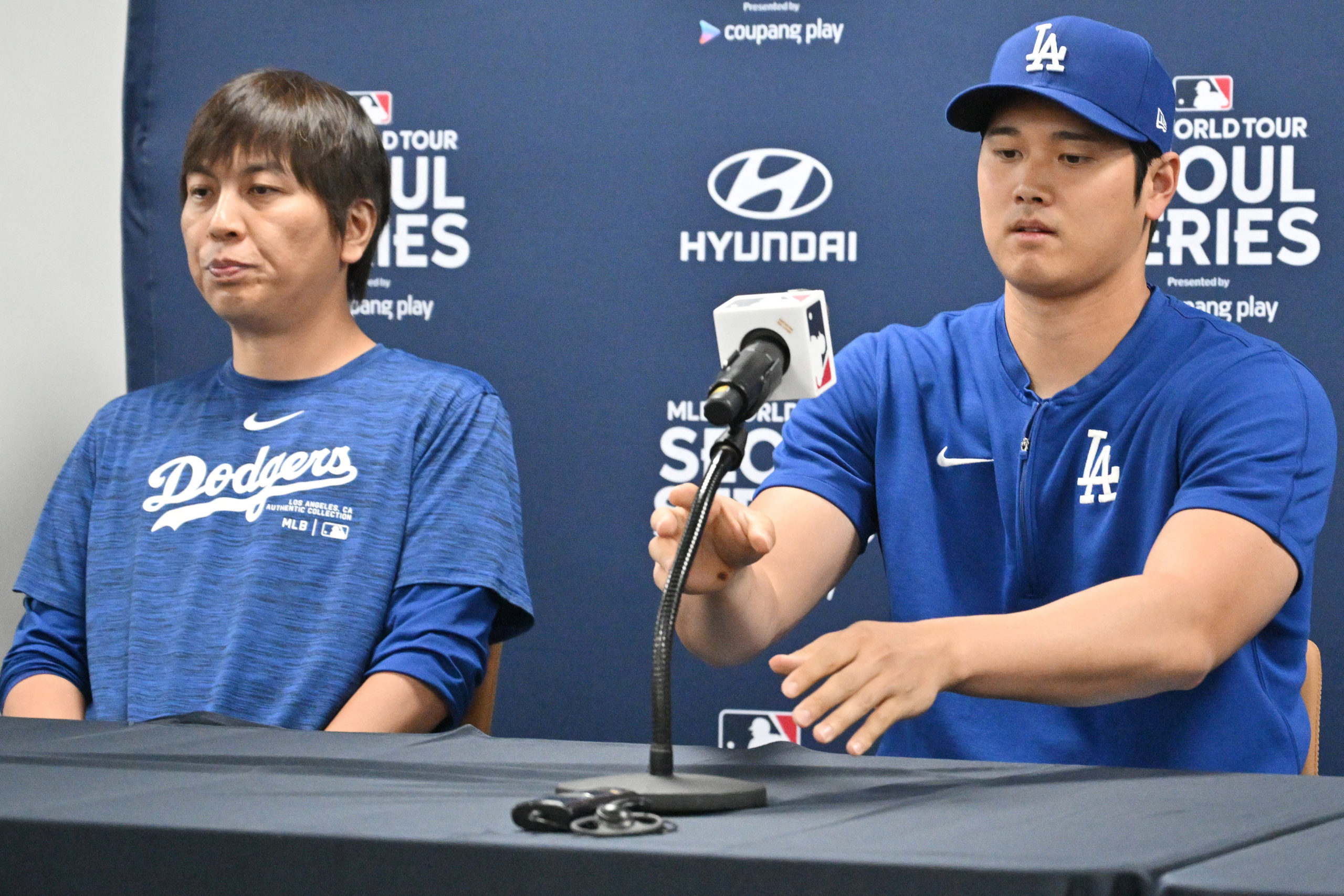 This picture taken on March 16, 2024 shows Los Angeles Dodgers' Shohei Ohtani (R) and his interpreter Ippei Mizuhara (L) attending a press conference at Gocheok Sky Dome in Seoul ahead of the 2024 MLB Seoul Series baseball game between Los Angeles Dodgers and San Diego Padres. The Los Angeles Dodgers said on March 21 they had fired Shohei Ohtani's interpreter after the Japanese baseball star's representatives claimed he had been the victim of "a massive theft" reported to involve millions of dollars. JUNG YEON-JE/AFP via Getty Images