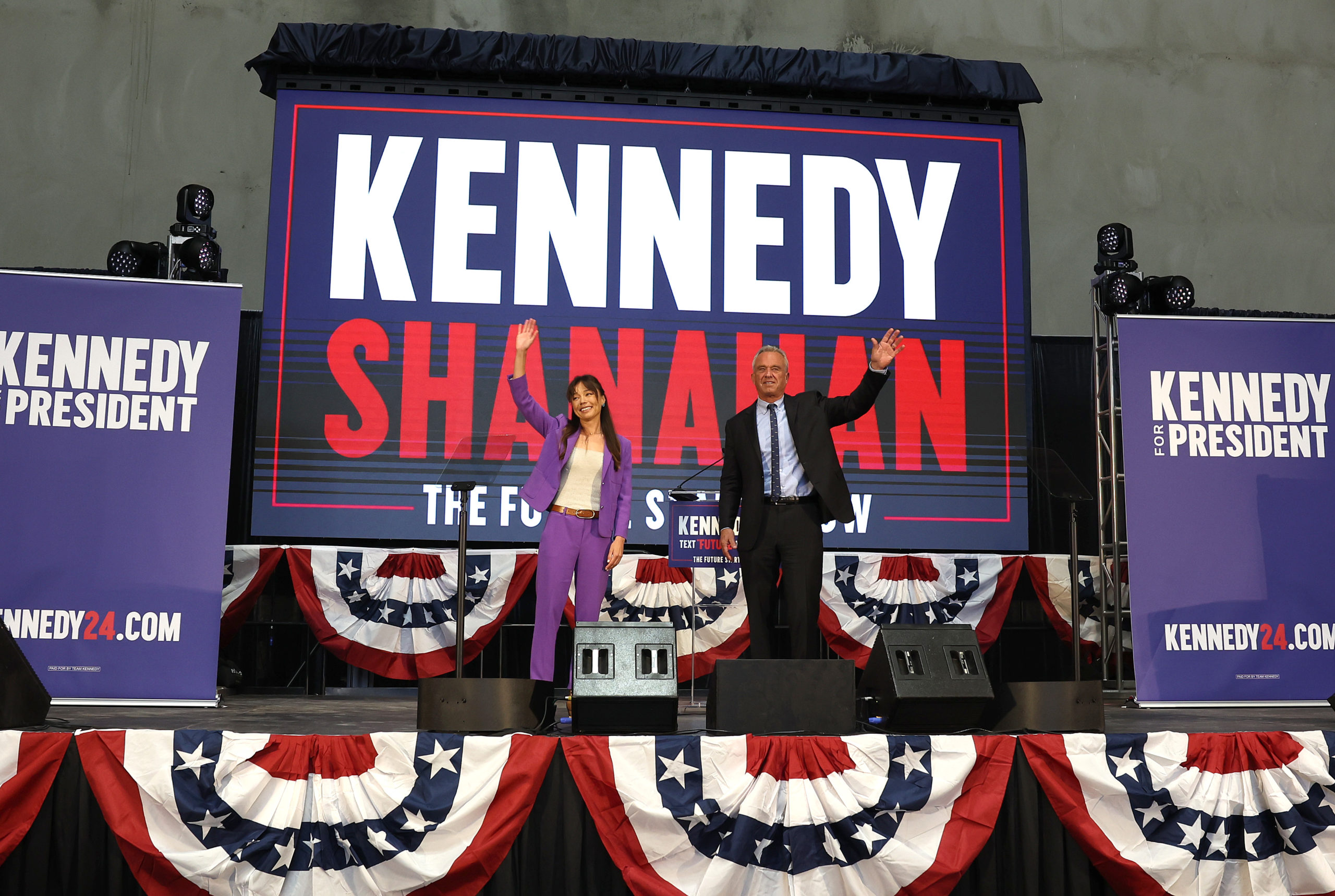 OAKLAND, CALIFORNIA - MARCH 26: Independent presidential candidate Robert F. Kennedy Jr. (R) and his vice presidential pick Nicole Shanahan take the stage during a campaign event to announce his pick for a running mate at the Henry J. Kaiser Event Center on March 26, 2024 in Oakland, California. Nicole Shanahan is an attorney and tech entrepreneur based in the San Francisco Bay Area. (Photo by Justin Sullivan/Getty Images)