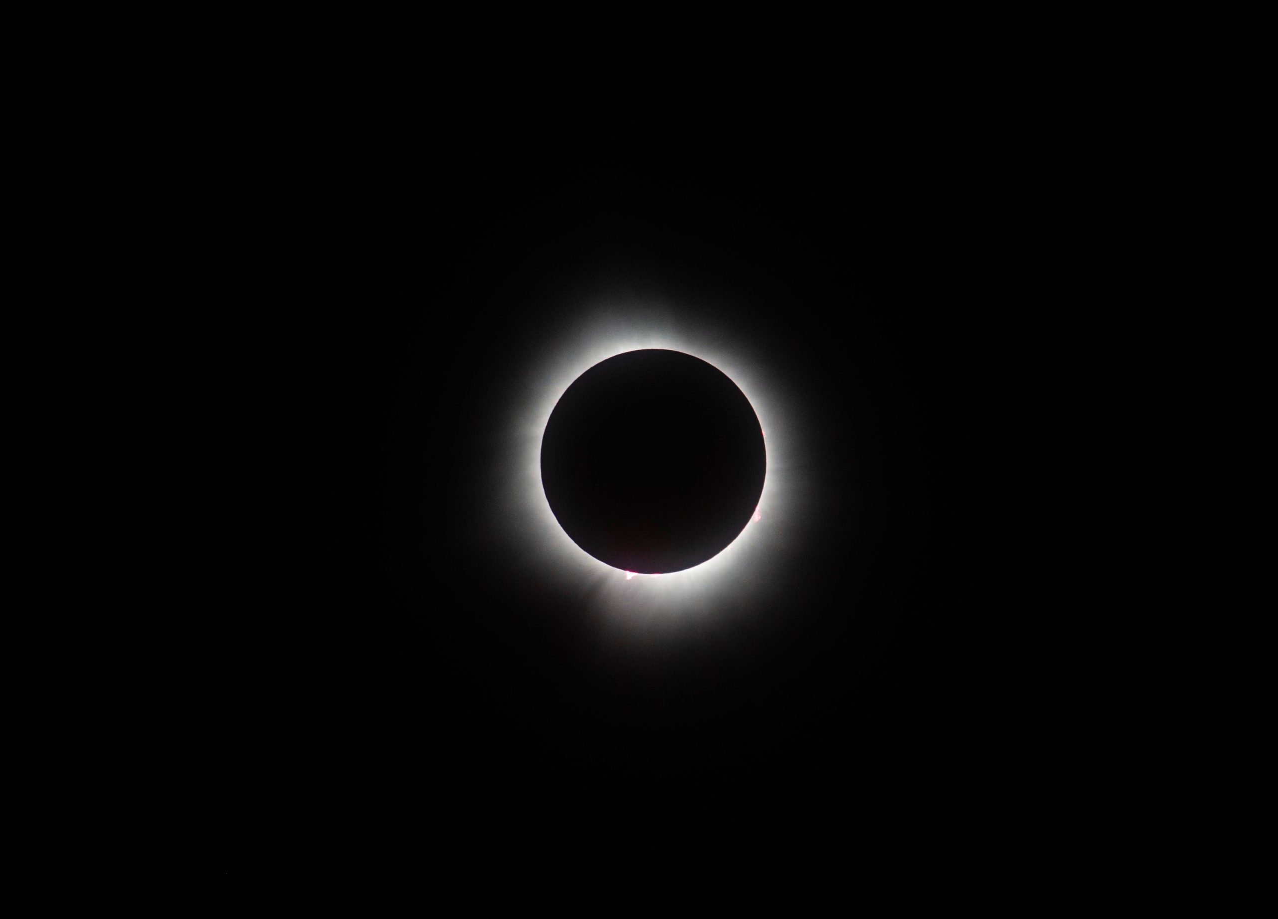 WAPAKONETA, OHIO - APRIL 8: The sun and the moon align completely, with solar prominences visible, during the total solar eclipse on April 8, 2024 in Wapakoneta, Ohio. Totality lasted for alomst four minutes in Ohio. Millions of people have flocked to areas across North America that are in the "path of totality" in order to experience a total solar eclipse. During the event, the moon will pass in between the sun and the Earth, appearing to block the sun. Matthew Hatcher/Getty Images