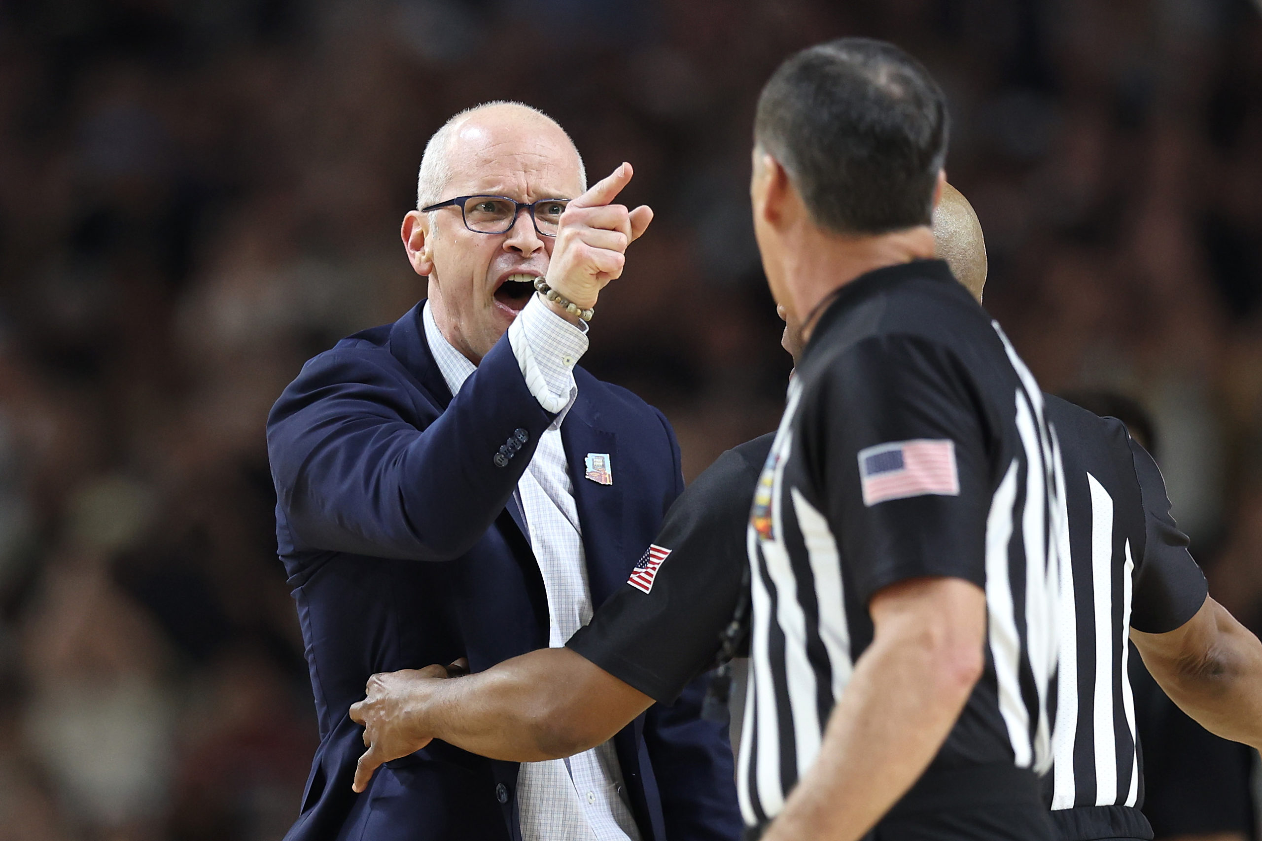 GLENDALE, ARIZONA - APRIL 08: Head coach Dan Hurley of the Connecticut Huskies argues with officials in the first half against the Purdue Boilermakers during the NCAA Men's Basketball Tournament National Championship game at State Farm Stadium on April 08, 2024 in Glendale, Arizona. Jamie Squire/Getty Images