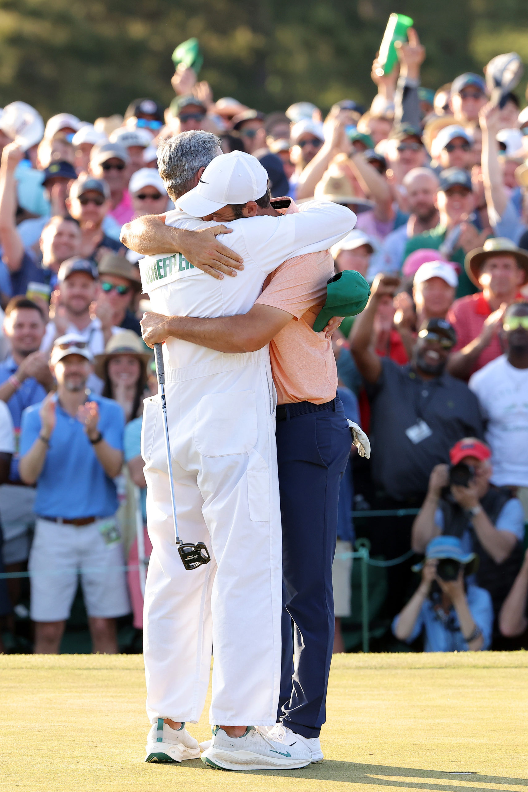 AUGUSTA, GEORGIA - APRIL 14: Scottie Scheffler of the United States and caddie Ted Scott celebrate on the 18th green after winning the 2024 Masters Tournament at Augusta National Golf Club on April 14, 2024 in Augusta, Georgia. Jamie Squire/Getty Images