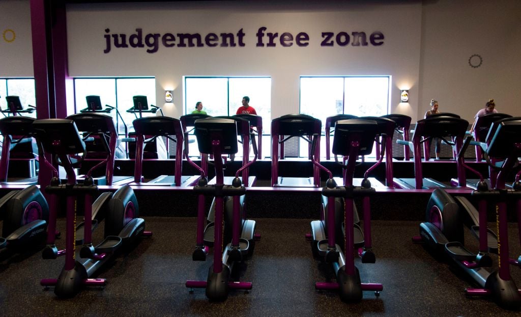 People exercise at Planet Fitness in the Columbia Mall on July 24, 2017 in Bloomsburg, Pennsylvania. - Mall space is being repurposed as more department store chains close stores that have traditionally served as "anchors" at malls. The Planet Fitness now occupies the space that was previously a Sears. The glass doors behind those exercising were the bay doors for Sears Automotive. Abandoned by the big brands, deserted by the young, the American mall, once temples of the shopping, have become ghost towns, victims of the explosion of online shopping. (Photo by Don EMMERT / AFP) / TO GO WITH AFP STORY by John BIERS, "Deserted, US shopping centers look for a future" (Photo by DON EMMERT/AFP via Getty Images)