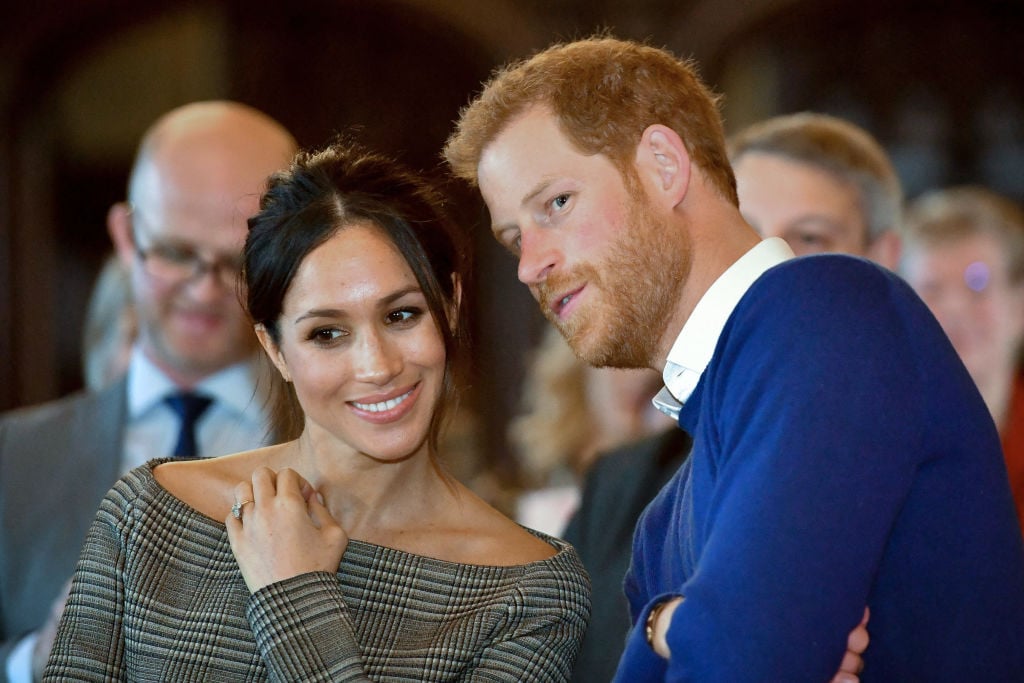 TOPSHOT - Britain's Prince Harry and his fiancée US actress Meghan Markle watch a dance performance by Jukebox Collective during a visit at Cardiff Castle in Cardiff, south Wales on January 18, 2018, for a day showcasing the rich culture and heritage of Wales. (Photo by Ben Birchall / POOL / AFP) (Photo by BEN BIRCHALL/POOL/AFP via Getty Images)