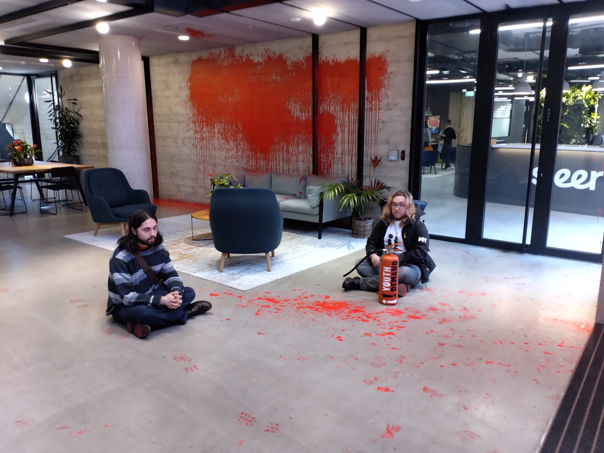 Youth Demand Protester sit in the U.K.'s Labour Party headquarters after their group sprayed paint inside and outside of the building. 4/8/24. Photo courtesy of Youth Demand.