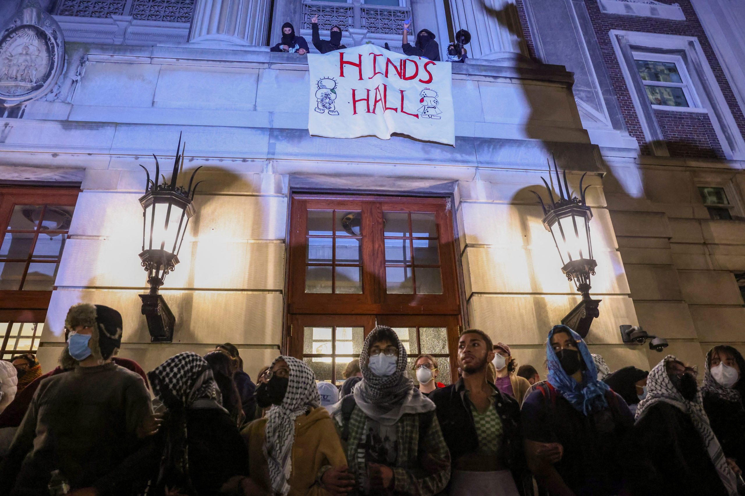 Protesters link arms outside Hamilton Hall barricading students inside the building at Columbia University, despite an order to disband the protest encampment supporting Palestinians or face suspension, during the ongoing conflict between Israel and the Palestinian Islamist group Hamas, in New York City, U.S., April 30, 2024. REUTERS/Caitlin Ochs
