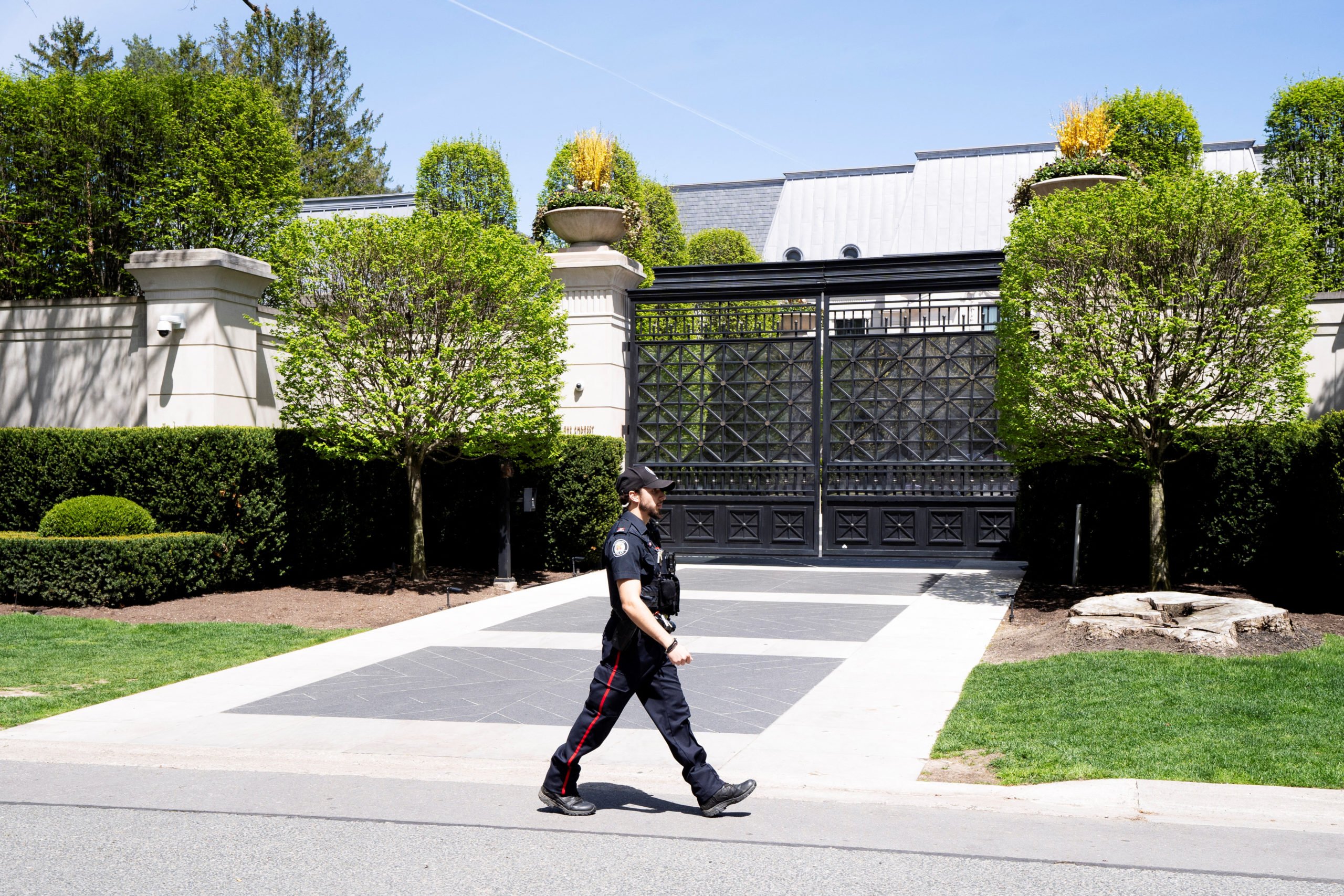 A Toronto Police officer walks outside of 21 Park Lane Circle after a security guard was shot outside the Bridle Path mansion of Canadian rap star Drake in Toronto, Ontario, Canada May 7, 2024. REUTERS/Arlyn McAdorey