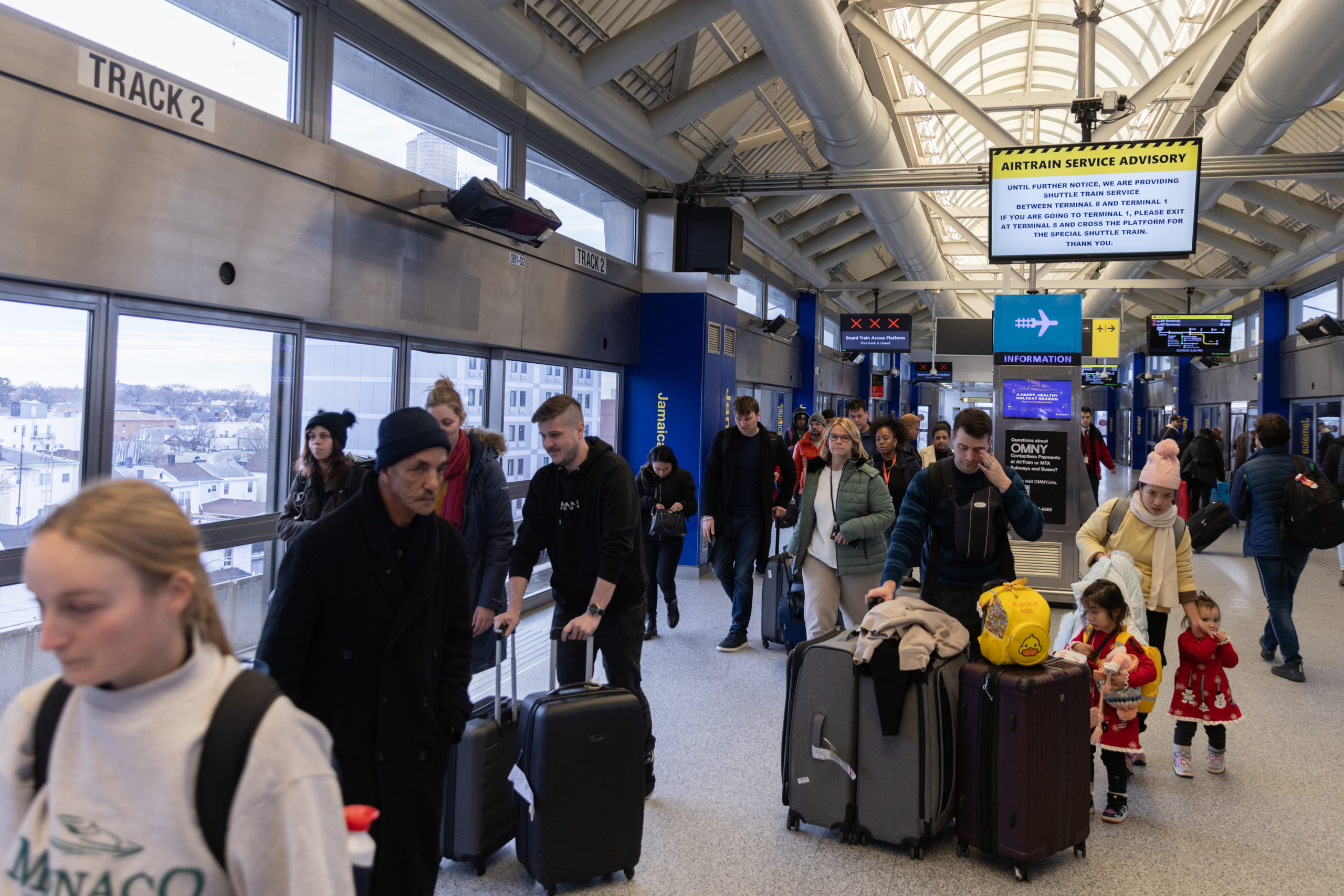 NEW YORK, NEW YORK - DECEMBER 23: Travelers walk with their luggage at John F. Kennedy International Airport (JFK) on December 23, 2023 in New York, New York. (Photo by Jeenah Moon/Getty Images)