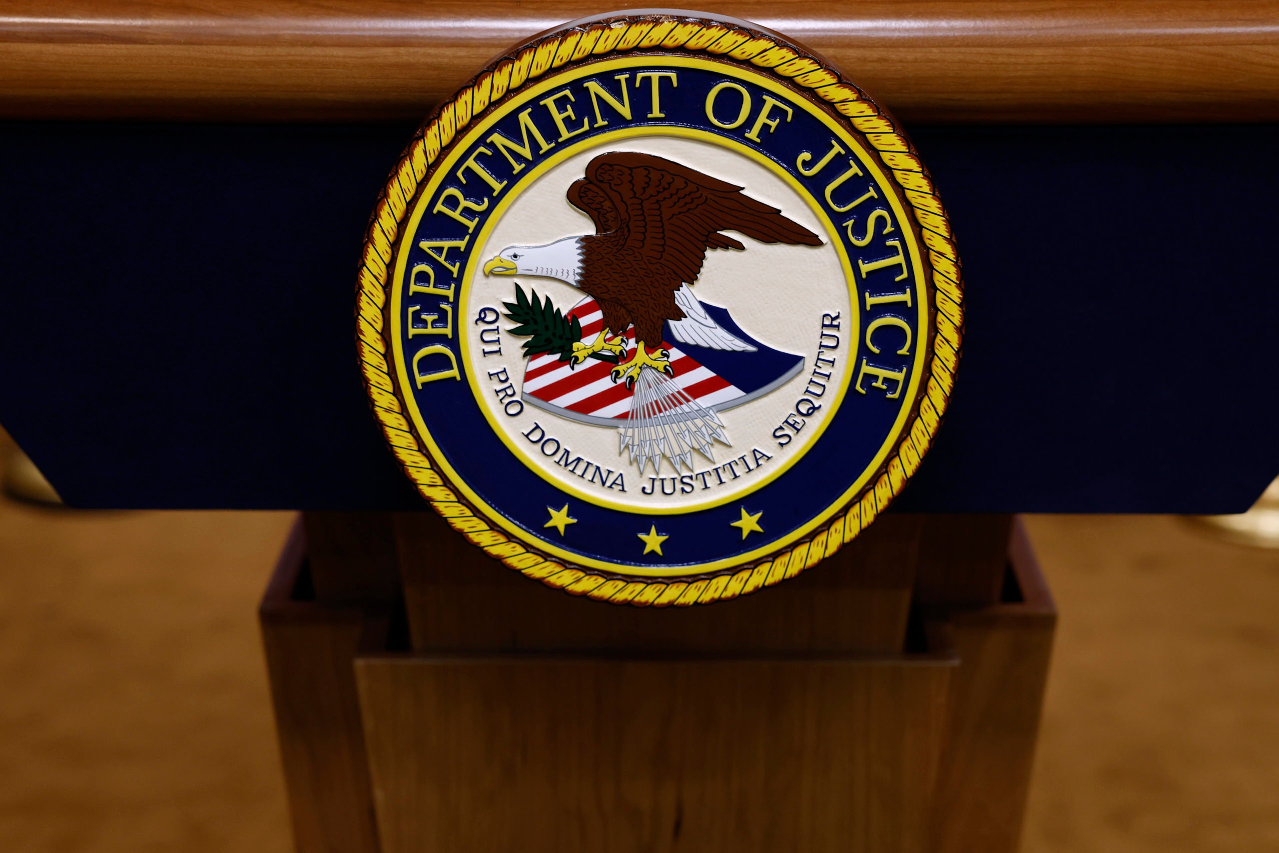 WASHINGTON, DC - MARCH 21: A seal for the Department of Justice is seen on a podium ahead of a news conference with U.S. Attorney General Merrick Garland at the Department of Justice Building on March 21, 2024 in Washington, DC. During the news conference, Garland and DOJ officials are expected to make an announcement about ongoing antitrust investigations. (Photo by Anna Moneymaker/Getty Images)