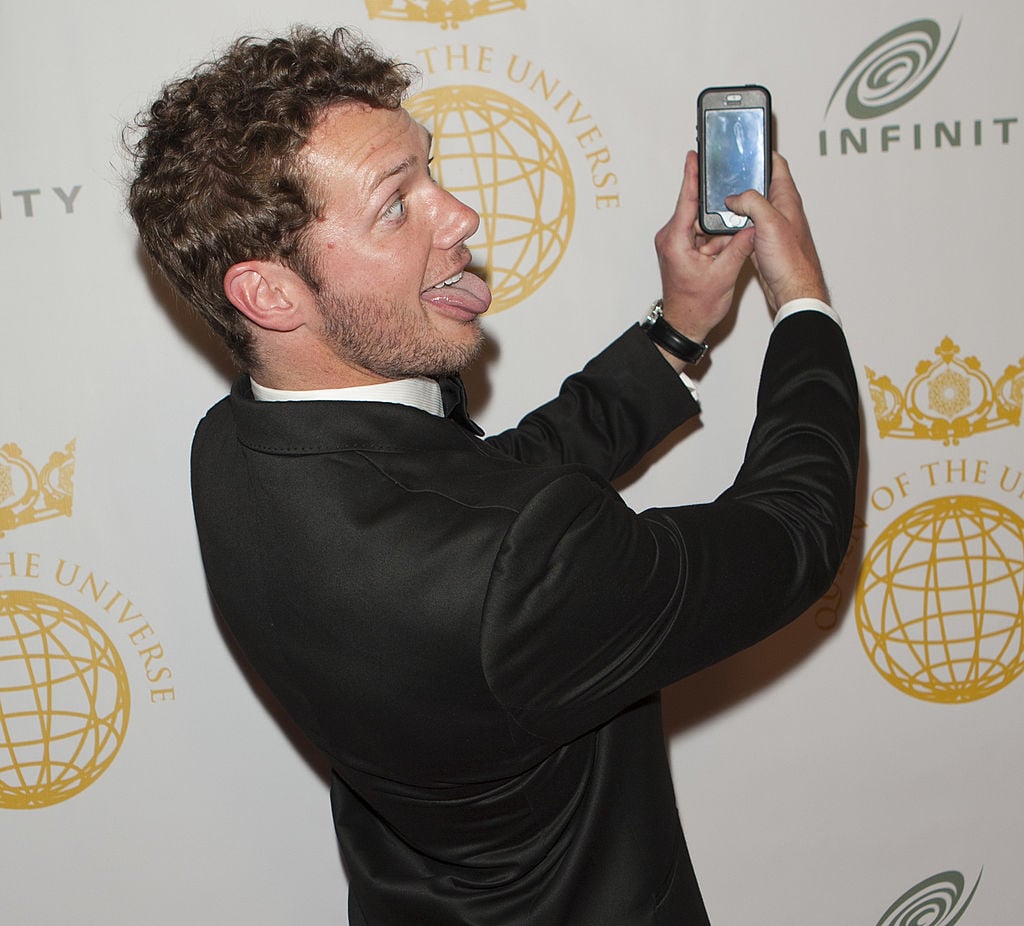 BEVERLY HILLS, CA - MARCH 16: Actor Johnny Wactor takes a selfie at Queen Of The Universe International Beauty Pageant at Saban Theatre on March 16, 2014 in Beverly Hills, California. (Photo by Michael Bezjian/WireImage)