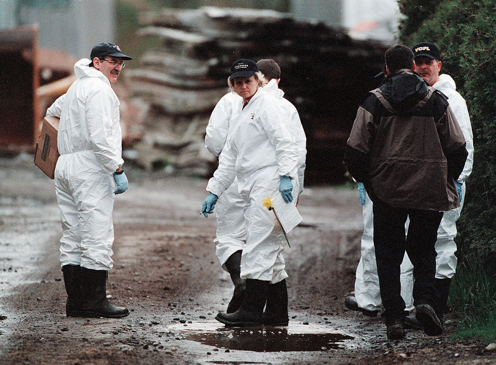 404096 01: Investigators of the Royal Canadian Mounted Police (RCMP) walk through the property owned by Dave and Robert William Pickton April 17, 2002 in Port Coquitlam, British Columbia. RCMP began a search on the property, known to locals as "Piggys Palace" as part of a continuing investigation of the 50 women who disappeared from the Vancouver area over the past two decades. (Photo by Don MacKinnon/Getty Images)