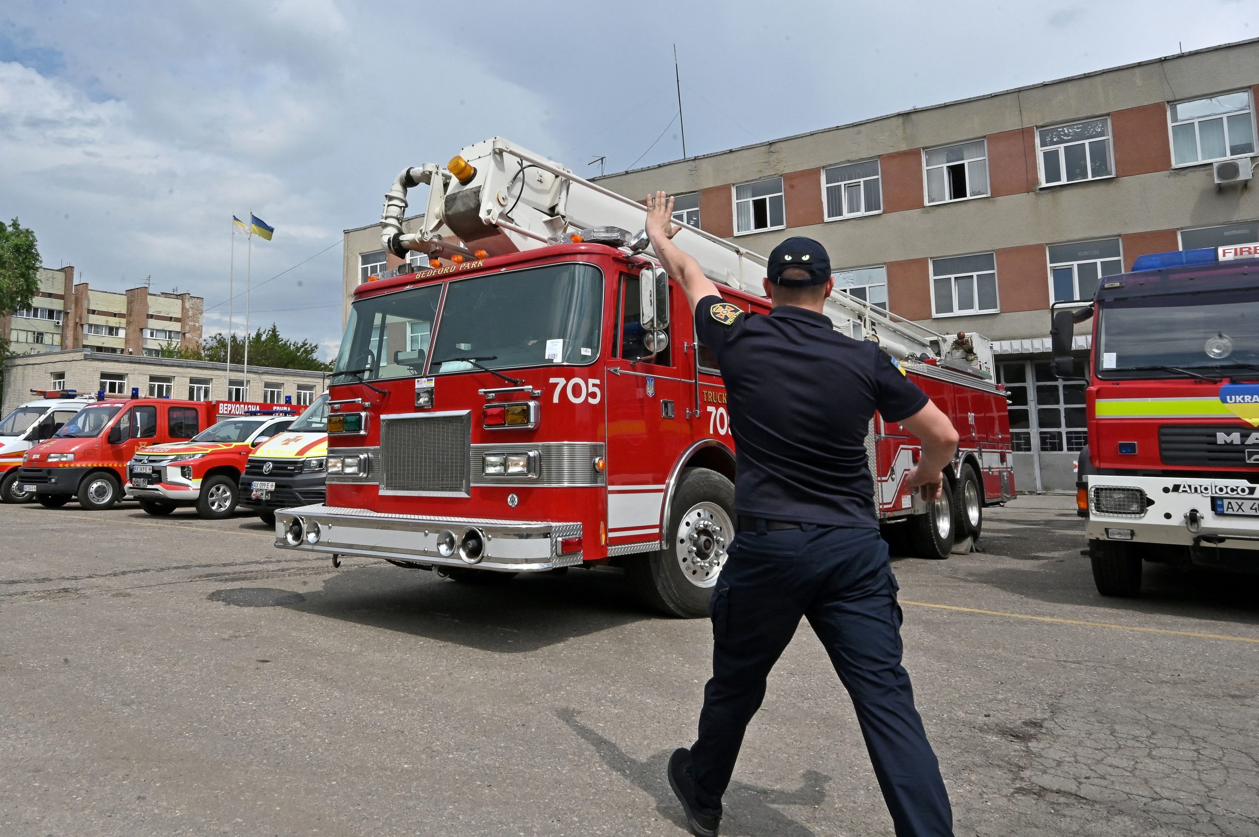An emergency responder gestures as Kharkiv rescuers inspect and test two fire trucks received as aid from United States fire departments, in Kharkiv, on May 25, 2023, amid Russia's military invasion on Ukraine. Since the beginning of the full-scale invasion, the Kharkiv garrison of the State Emergency Service lost 10 units of fire-rescue equipment, and another 53 vehicles were significantly damaged as a result of shelling. (Photo by SERGEY BOBOK/AFP via Getty Images)