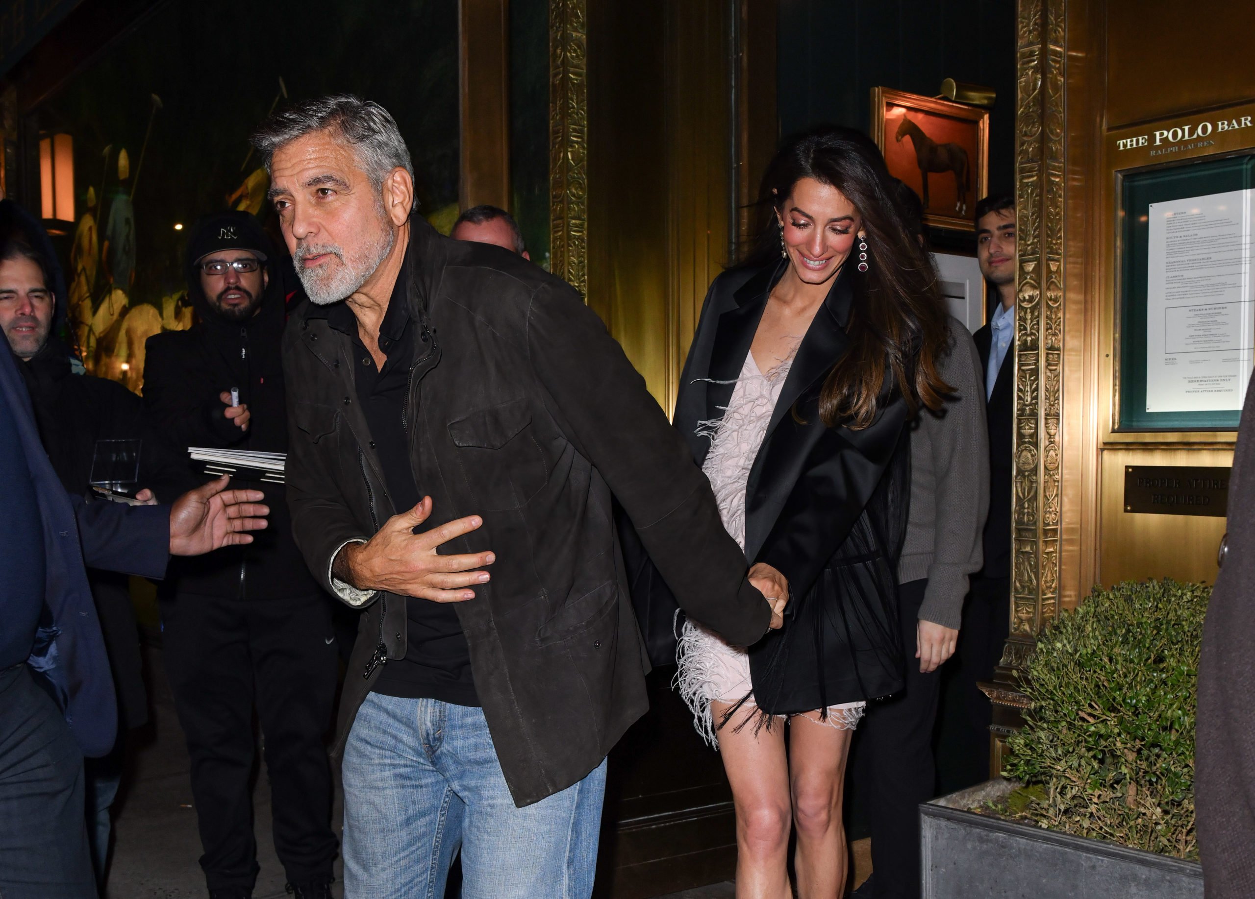 NEW YORK, NEW YORK - DECEMBER 14: George Clooney and Amal Clooney leave the Polo Bar on December 14, 2023 in New York City. (Photo by James Devaney/GC Images)
