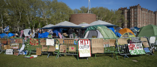 Signs and flags are pictured at a pro-Palestinian encampment on the lawn of the Stratton Student Center campus at the Massachusetts Institute of Technology (MIT) in Cambridge, Massachusetts, on May 9, 2024. The remaining protesters marched across the MIT campus to a pro-Palestinian encampment in front of MIT Stratton Student Center. (Photo by Rick Friedman / AFP) (Photo by RICK FRIEDMAN/AFP via Getty Images)