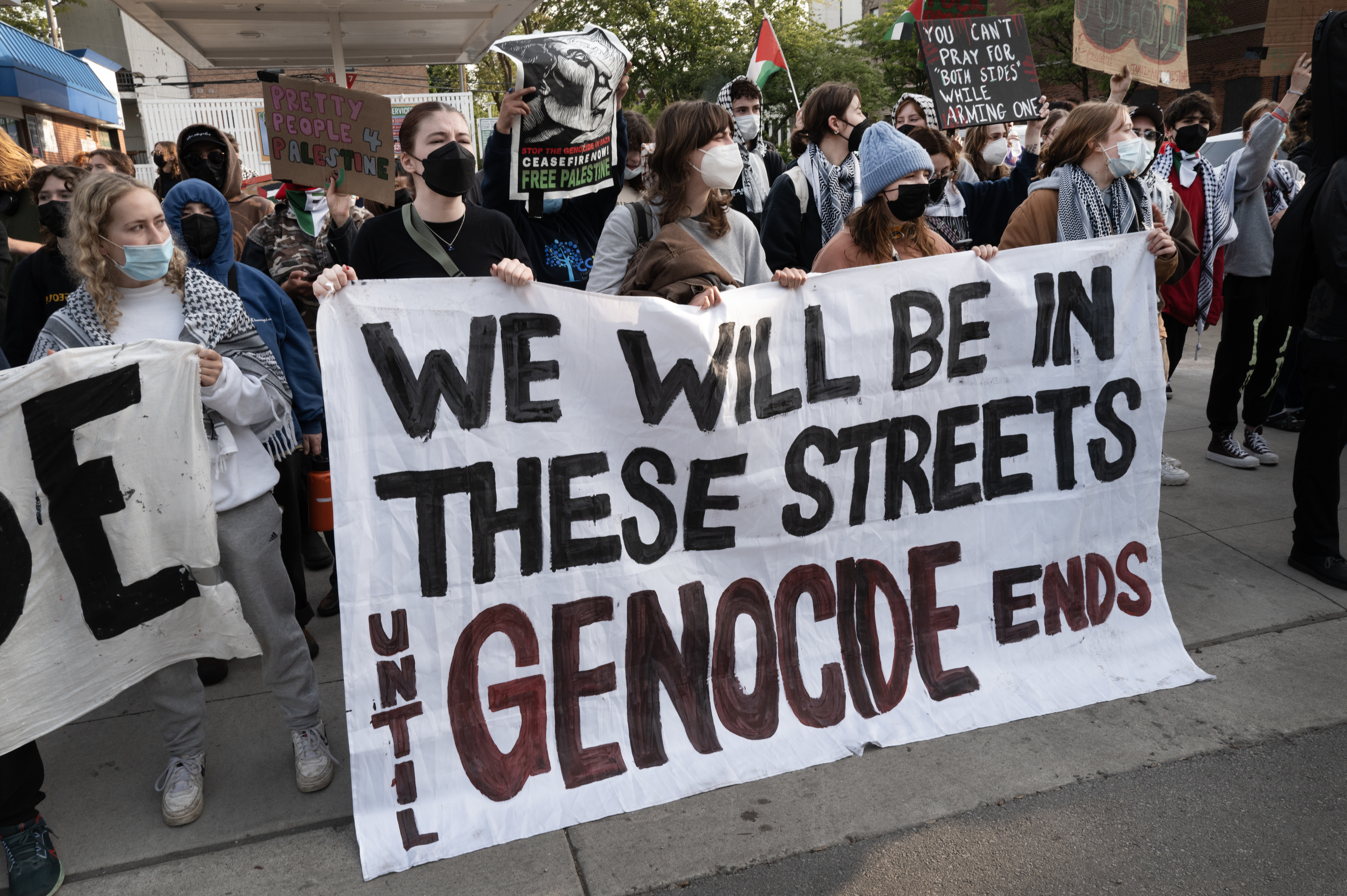 CHICAGO, ILLINOIS - MAY 16: Activist protest across the street from campus while workers and police remove a pro-Palestinian encampment at DePaul University on May 16, 2024 in Chicago, Illinois. The encampment was one of many that popped up on campuses around the country to protest Israel's actions in Gaza. At least two demonstrators were reported detained by police as the camp was being dismantled. (Photo by Scott Olson/Getty Images)