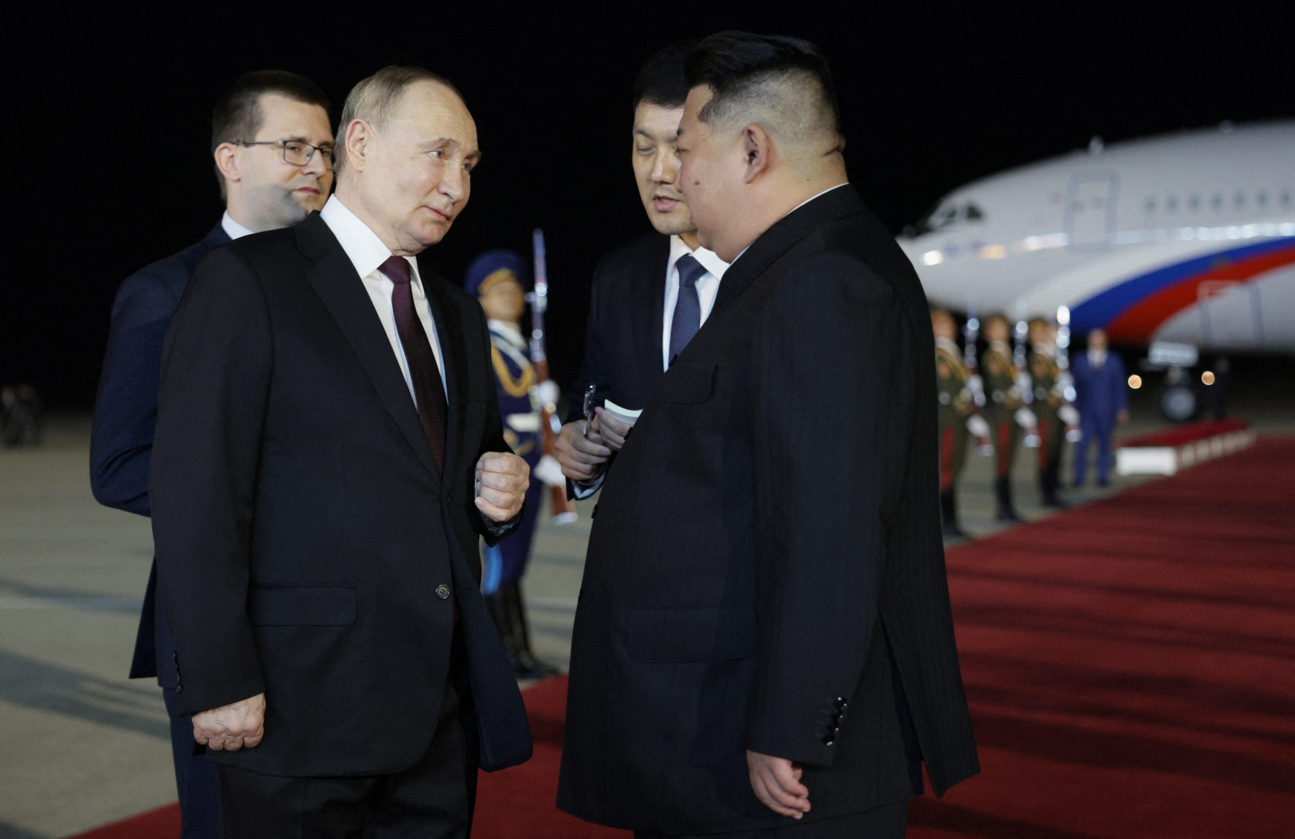 In this pool photograph distributed by the Russian state agency Sputnik, North Korea's leader Kim Jong Un (R) greets Russian President Vladimir Putin during a welcoming ceremony upon Putin's arrival in Pyongyang, early on June 19, 2024. Russian President Vladimir Putin landed in North Korea early on June 19, the Kremlin said, kicking off a visit set to boost defence ties between the two nuclear-armed countries as Moscow pursues its war in Ukraine. GAVRIIL GRIGOROV/POOL/AFP via Getty Images
