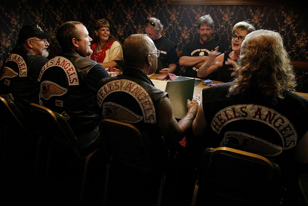 QUINCY, IL - AUGUST 23: Members of the Hells Angels motorcycle club, with wives and friends, order dinner at a restaurant August 23, 2003 in Quincy, Illinois. The motorcycle club was in Quincy for a book signing event and party honoring Sonny Barger (2nd-R/back to camera), founder of the Oakland, California charter of the Hells Angels. (Photo by Scott Olson/Getty Images)