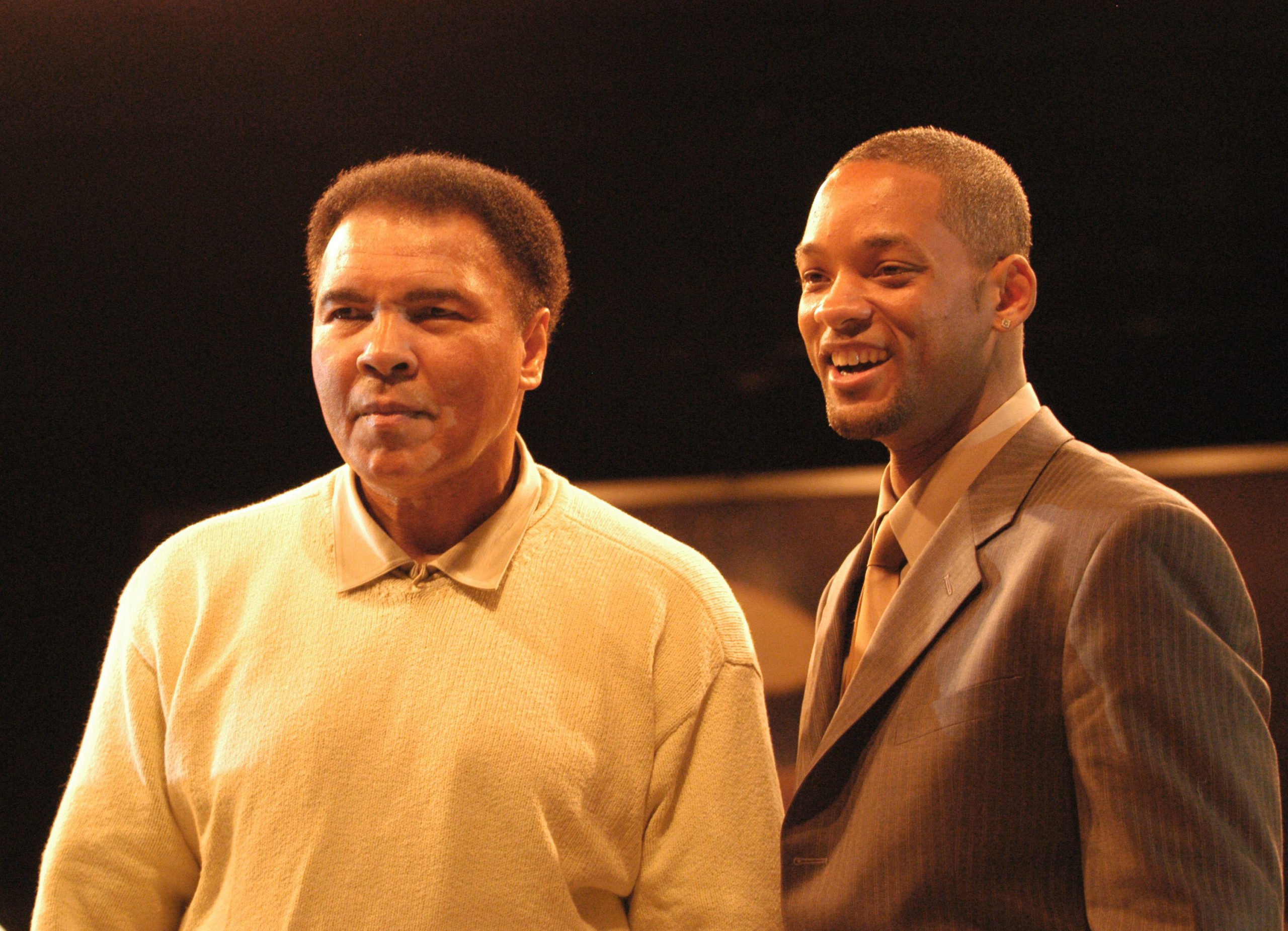 MIAMI - DECEMBER 6: Boxing legend Muhammad Ali (L) stands with actor Will Smith at the Miami Art Basel Taschen book premiere of Ali's new book, "GOAT - Greatest Of All Time" at the Miami Convention Center December 6, 2003 in Miami, Florida. (Photo by Gregorio Binuya/Getty Images)