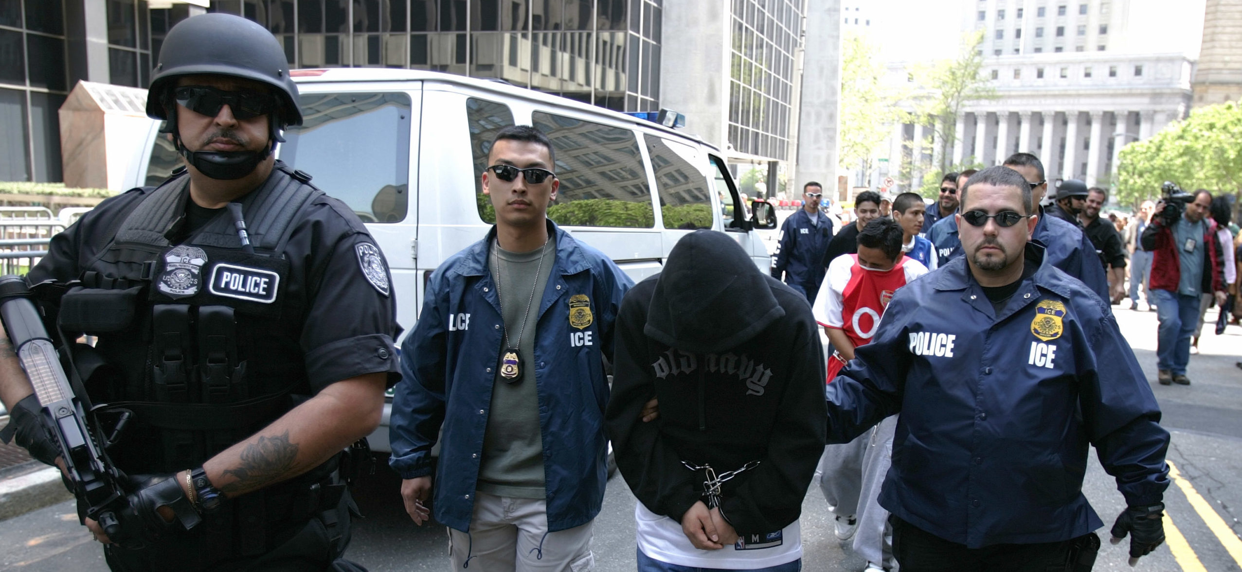 NEW YORK - MAY 11: Special agents working for Immigration and Customs Enforcement (ICE) escort members of a Mexican gang to court following their arrests May 11, 2005 in New York City. The gang members from the Mexican Mafia are illegal residents and will be deported by officials. ICE officers are part of the federal government's Department of Homeland Security. (Photo by Robert Nickelsberg/Getty Images)
