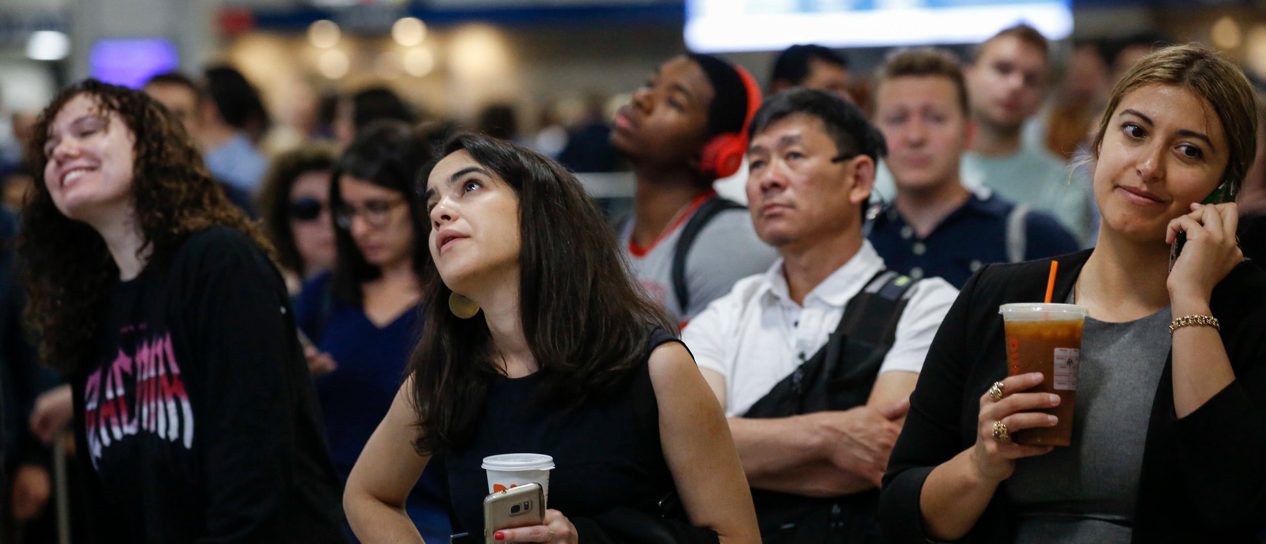 Passengers watch the departures board as they wait to board delayed Amtrak trains at New York Penn Station, June 19, 2019 in New York City. Power outage issues on Amtrak and New Jersey Transit train lines halted all trains in and out of New York Penn Station on Wednesday morning. (Photo by Drew Angerer/Getty Images)
