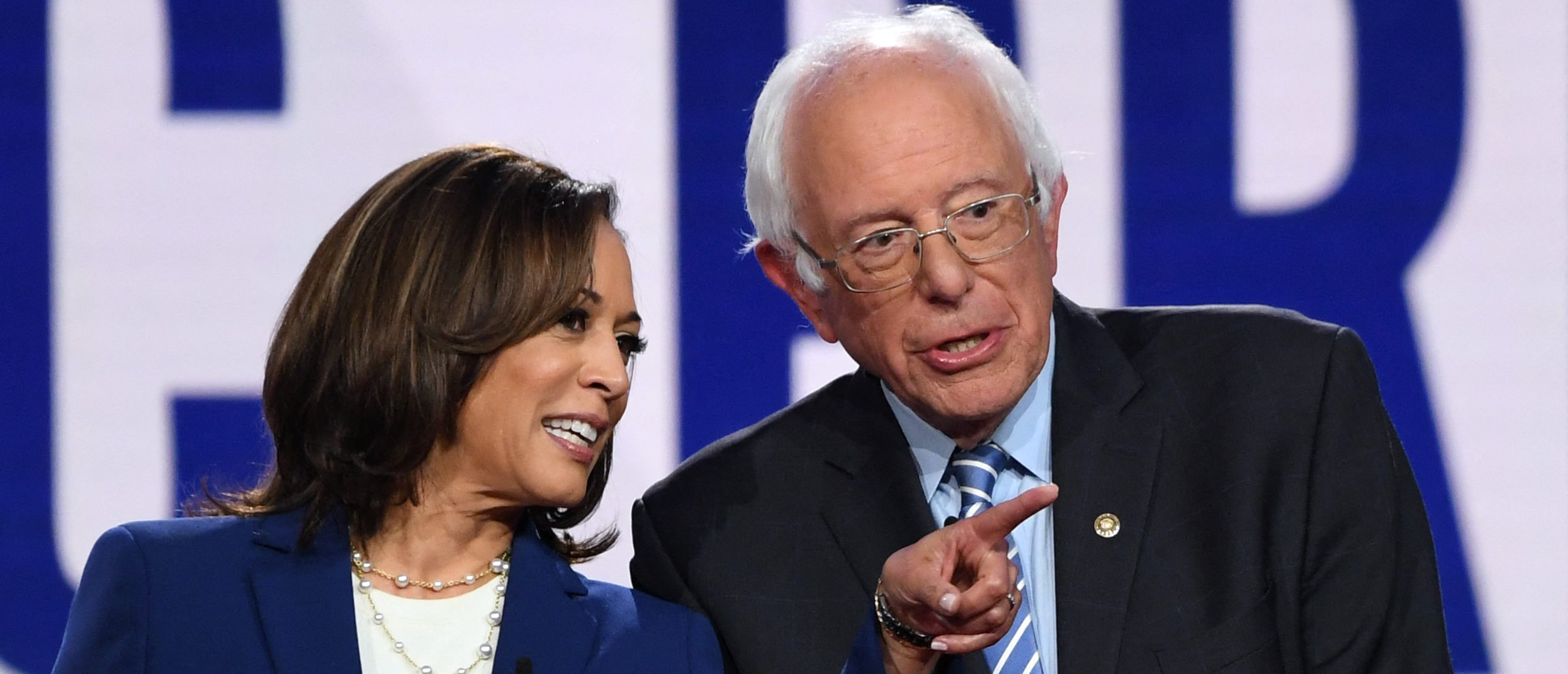 Democratic presidential hopefuls California Senator Kamala Harris (L) and Vermont Senator Bernie Sanders speak as they arrive onstage for the fourth Democratic primary debate of the 2020 presidential campaign season co-hosted by The New York Times and CNN at Otterbein University in Westerville, Ohio on October 15, 2019.