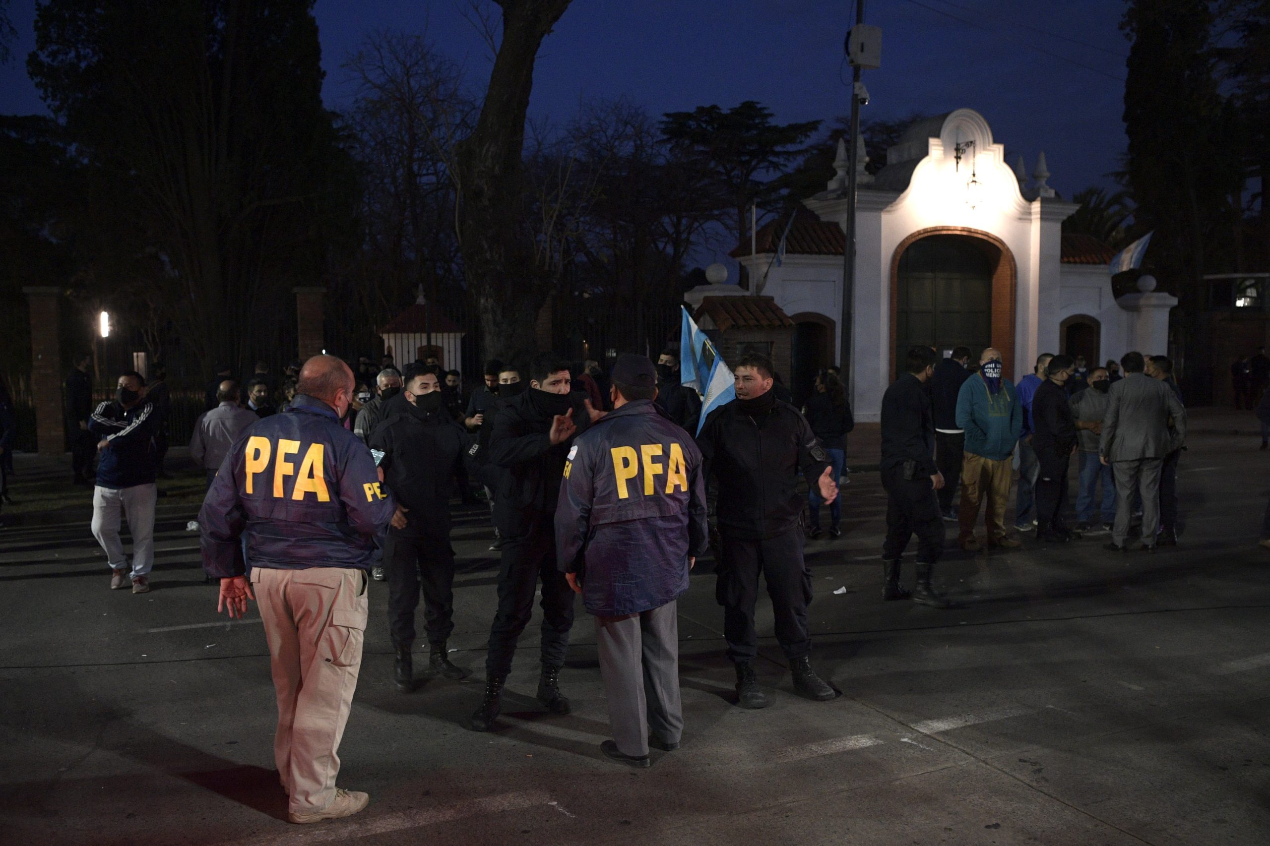 Members of the Buenos Aires province police, that attend a demonstration in demand of a rise in their wages and better working conditions, argue with Federal policemen (PFA) before leaving from the front of the Olivos presidential residence after the arrival of supporters of Argentina's President Alberto Fernandez in Buenos Aires outskirts, Argentina, on September 9, 2020, amid the new coronavirus pandemic. (Photo by JUAN MABROMATA/AFP via Getty Images)