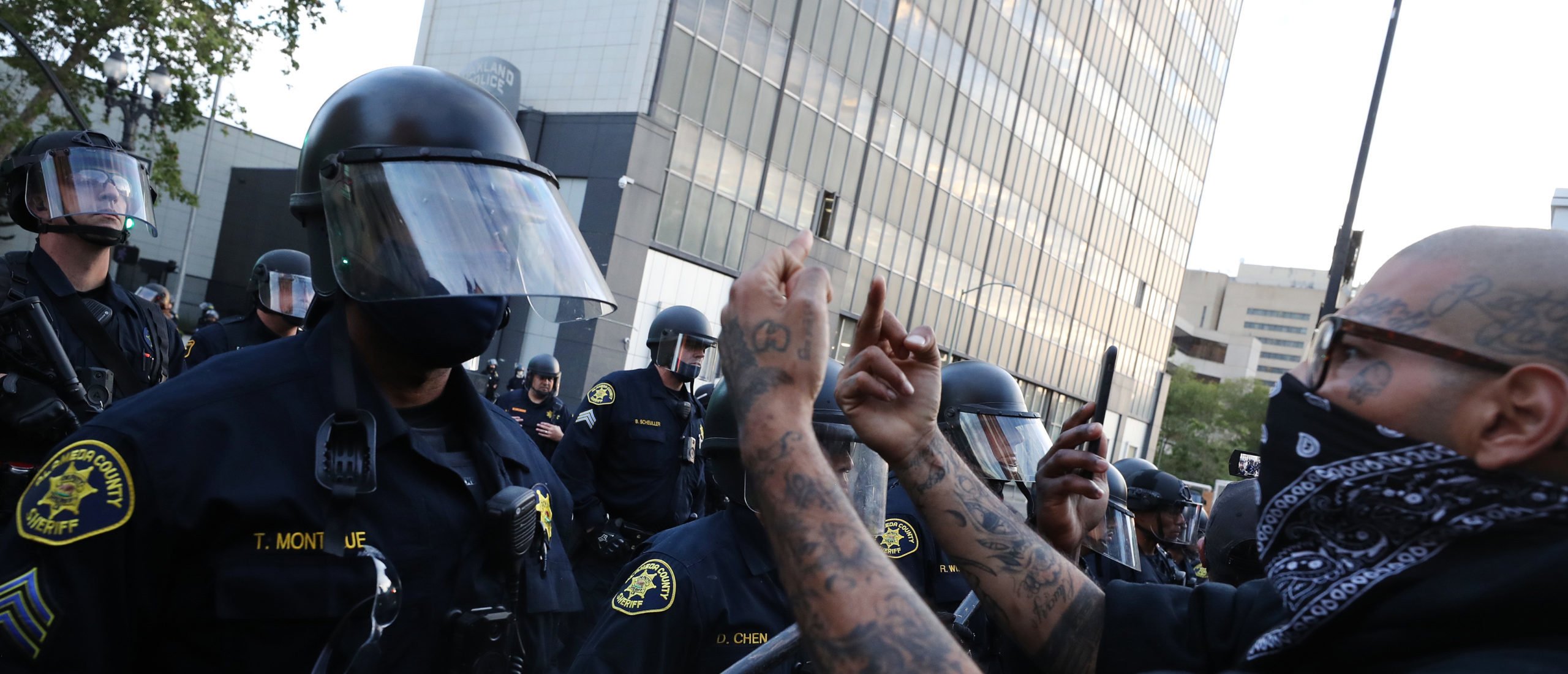 A man a conveys his message to police during a protest sparked by the death of George Floyd while in police custody on May 29, 2020 in Oakland, California. Earlier today, former Minneapolis police officer Derek Chauvin was taken into custody for Floyd's death. Chauvin has been accused of kneeling on Floyd's neck as he pleaded with him about not being able to breathe. Floyd was pronounced dead a short while later. Chauvin and 3 other officers, who were involved in the arrest, were fired from the police department after a video of the arrest was circulated. (Photo by Justin Sullivan/Getty Images)