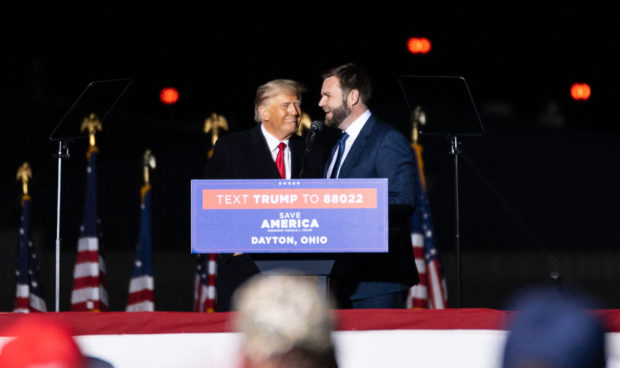 Former US President Donald Trump welcomes epublican US Senate candidate, J.D. Vance on stage during a campaign rally, on the eve of the US midterm elections, in Vandalia, Ohio, on November 7, 2022. (Photo by Megan JELINGER / AFP) (Photo by MEGAN JELINGER/AFP via Getty Images)