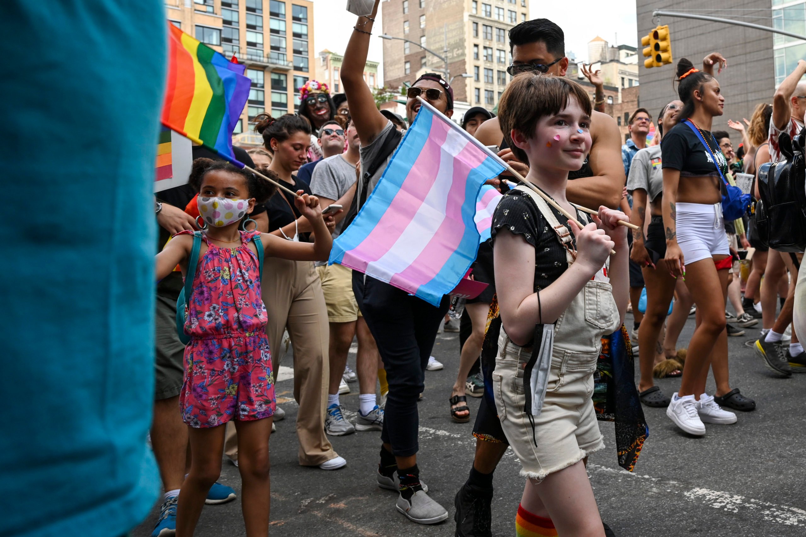 NEW YORK, NEW YORK - JUNE 27: A child carrying Trans pride flags marches in the 3rd Annual Queer Liberation March on June 27, 2021 in New York City. The Queer Liberation March is a “people’s march” working to "reclaim the spirit and meaning of Pride” with a motto of "No Corps - No Cops - No BS" according to their website. This year’s march started in Bryant Park and wended near The Stonewall Inn in the West Village. (Photo by Alexi Rosenfeld/Getty Images)