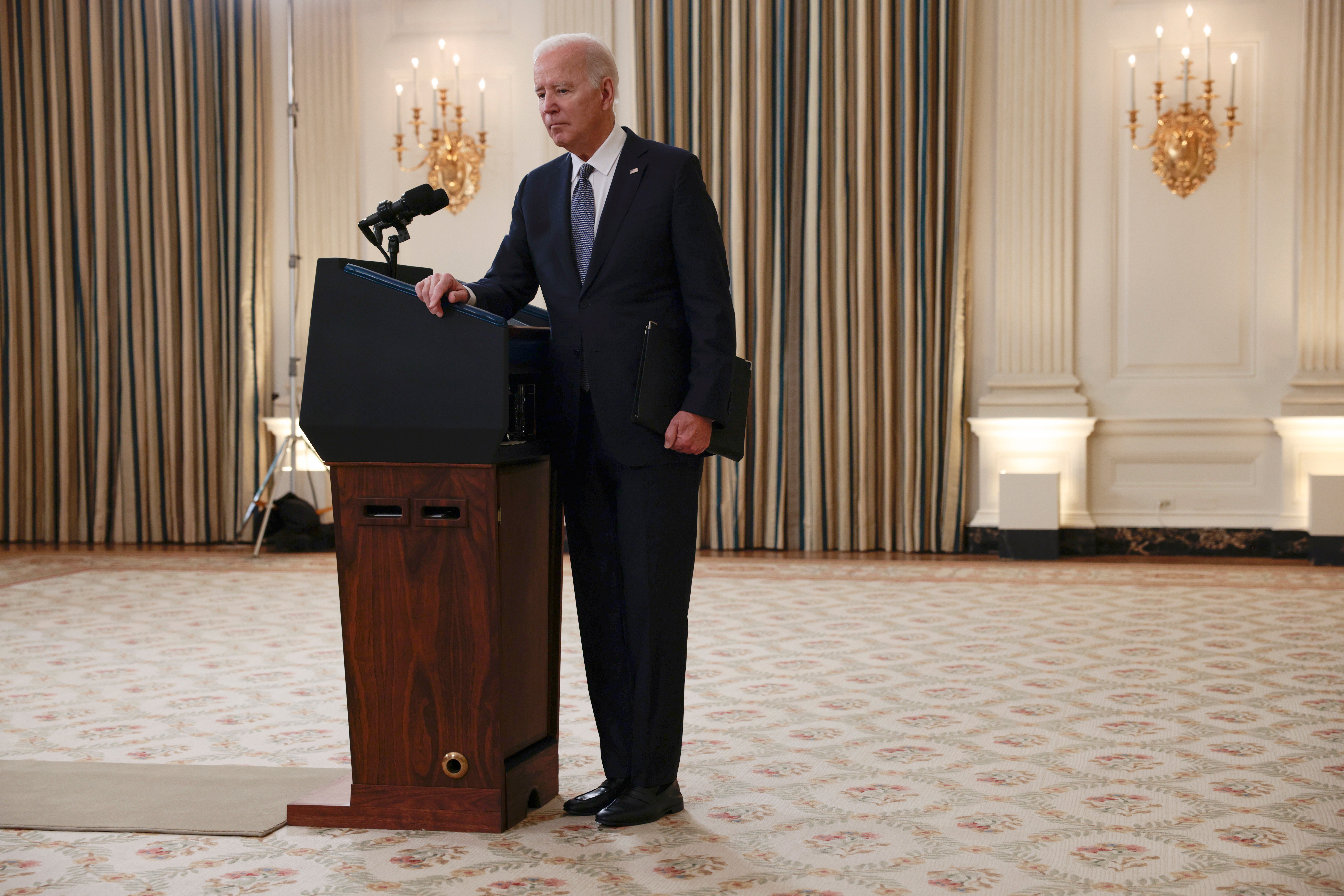 WASHINGTON, DC - DECEMBER 03: U.S. President Joe Biden listens to a reporter's question after giving remarks on the November jobs report in the State Dining Room of the White House on December 03, 2021 in Washington, DC. According to the U.S. Labor Department, the economy added 210,000 jobs in November and the unemployment rate fell to 4.2%. (Photo by Anna Moneymaker/Getty Images)