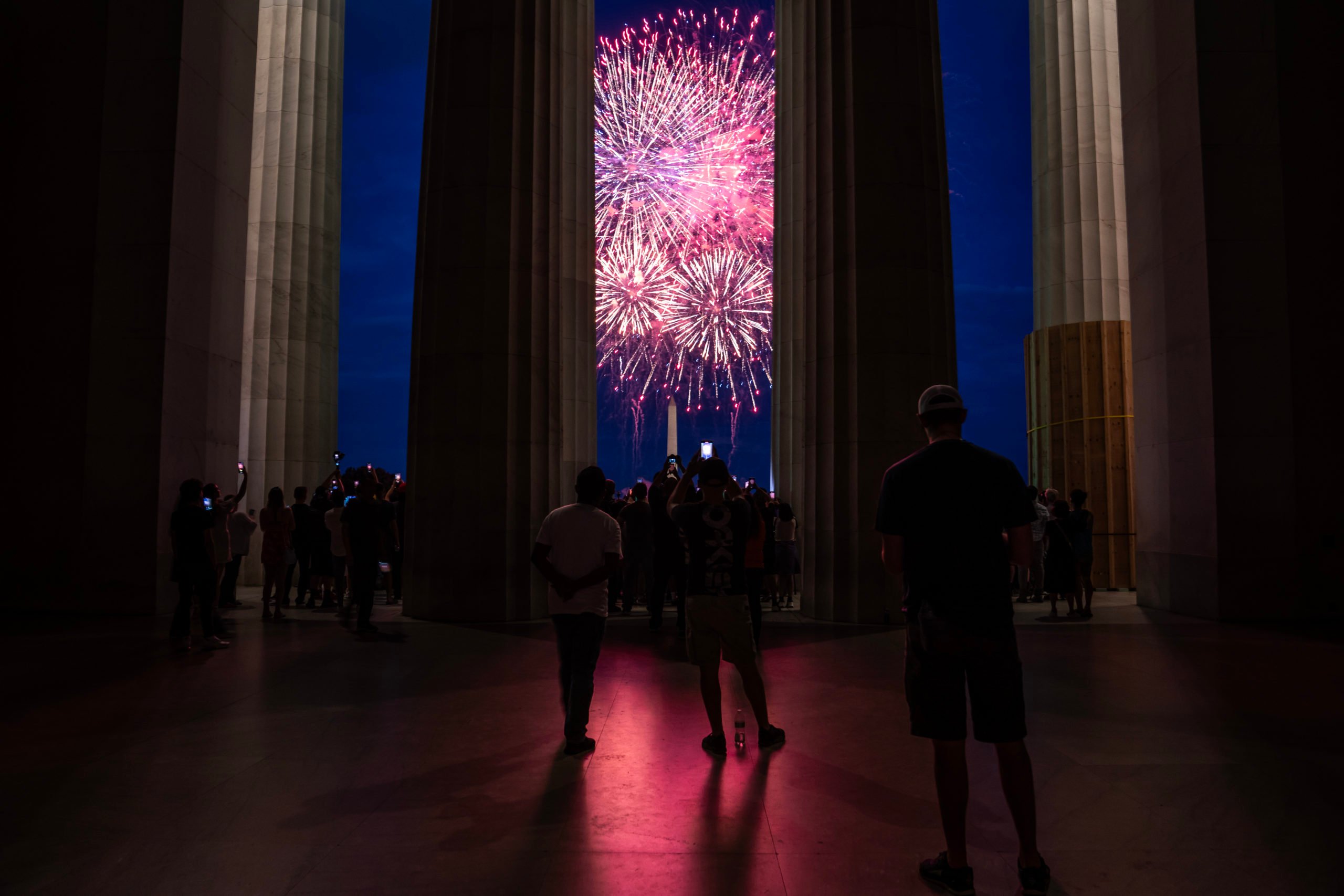 WASHINGTON, DC - JULY 4: Spectators watch as fireworks erupt over the Washington Monument during the Independence Day fireworks display along the National Mall on July 4, 2023 in Washington, DC. Crowds of people came together to partake in the annual event commemorating the Fourth of July celebration. (Photo by Nathan Howard/Getty Images)