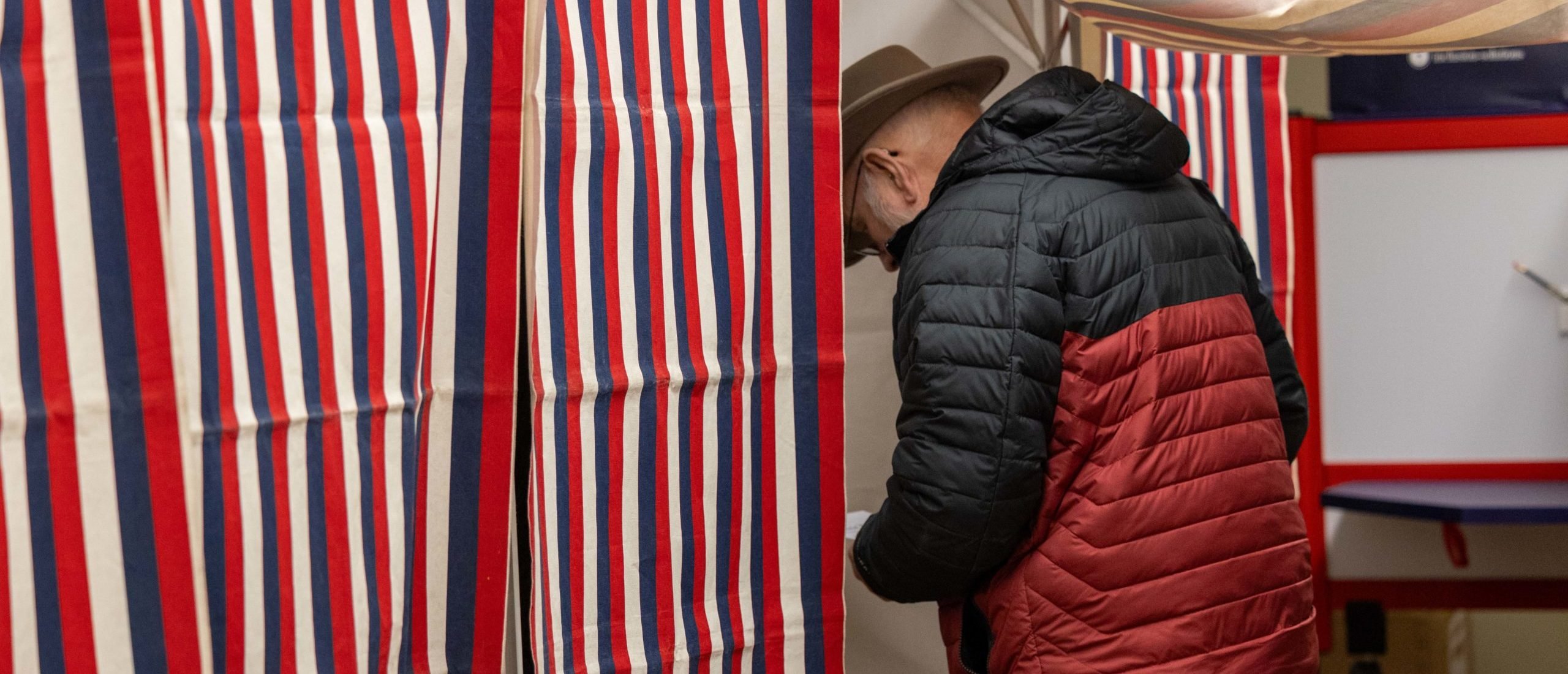 NORTHUMBERLAND, NEW HAMPSHIRE - JANUARY 23: A voter enters the voting booth to fill out their ballot at a polling location on January 23, 2024 in Northumberland, New Hampshire. With Florida Governor Ron DeSantis dropping out of the race two days earlier, Republican presidential candidates former President Donald Trump and former UN Ambassador Nikki Haley are battling it out in this first-in-the-nation primary. (Photo by Scott Eisen/Getty Images)