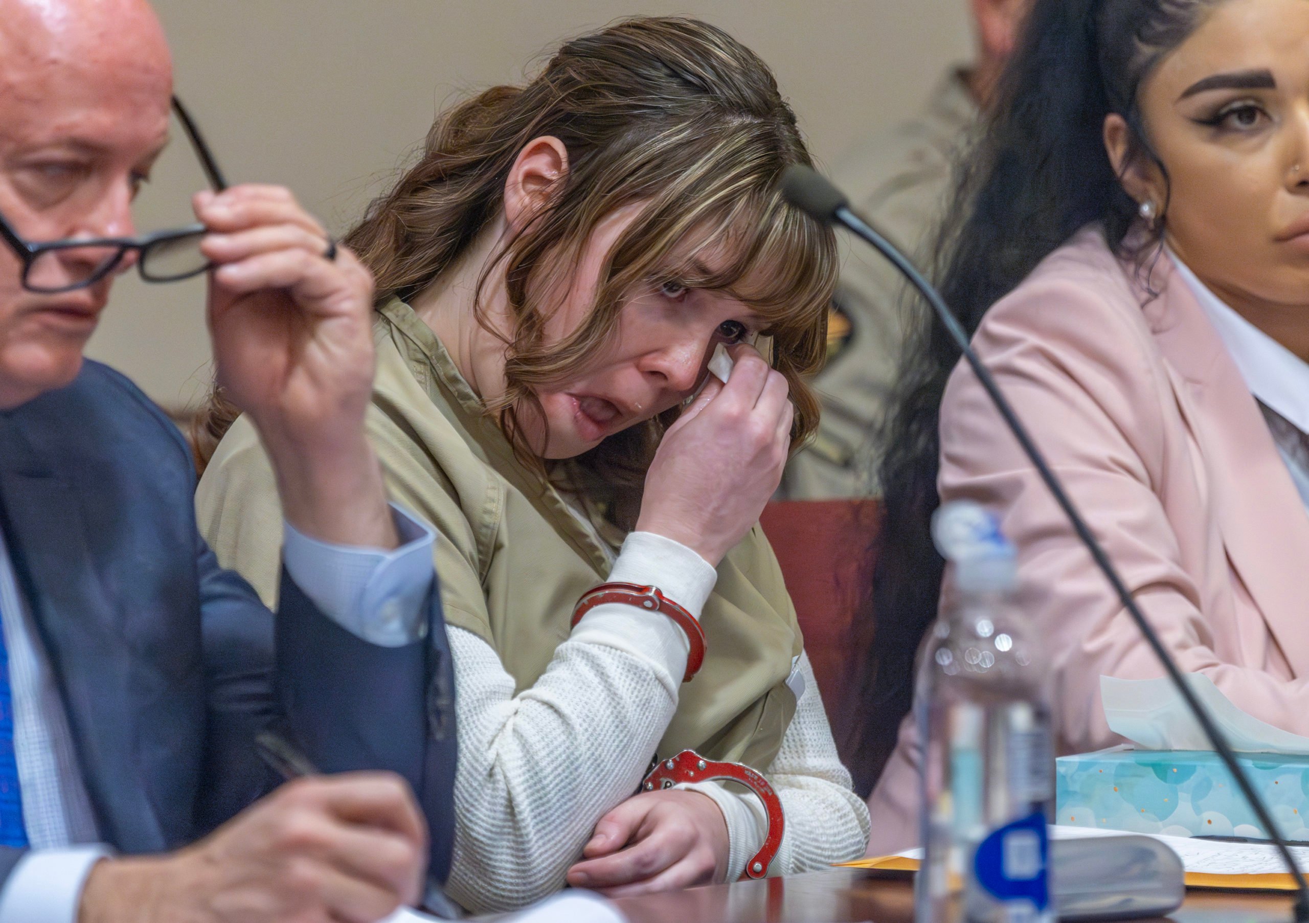 SANTA FE, NEW MEXICO - APRIL 15: Rust armorer Hannah Gutierrez-Reed wipes her tears at her sentencing at district court on April 15, 2024 in Santa Fe, New Mexico. Armorer on the set of the Western film "Rust," Gutierrez Reed was convicted by a jury of involuntary manslaughter in the death of cinematographer Halyna Hutchins who was fatally shot by Alec Baldwin in 2021. Gutierrez Reed was sentenced to 18 months in prison. (Photo by Luis Sánchez Saturno-Pool/Getty Images)