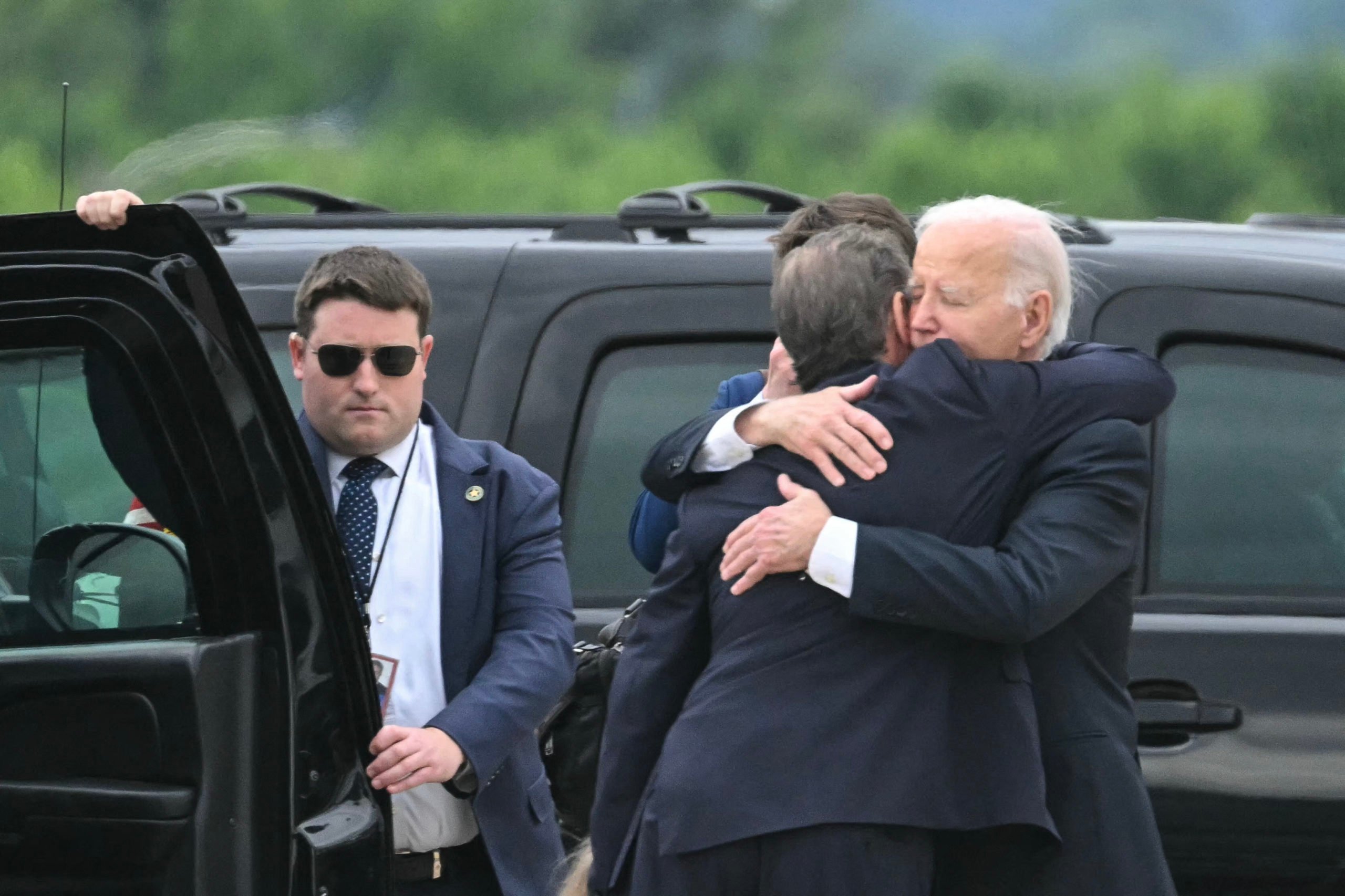US President Joe Biden hugs his son Hunter Biden upon arrival at Delaware Air National Guard Base in New Castle, Delaware, on June 11, 2024, as he travels to Wilmington, Delaware. A jury found Hunter Biden guilty on June 11 on federal gun charges in a historic first criminal prosecution of the child of a sitting US president. The 54-year-old son of President Joe Biden was convicted on all three of the federal charges facing him, CNN and other US media reported. (Photo by ANDREW CABALLERO-REYNOLDS / AFP) (Photo by ANDREW CABALLERO-REYNOLDS/AFP via Getty Images)