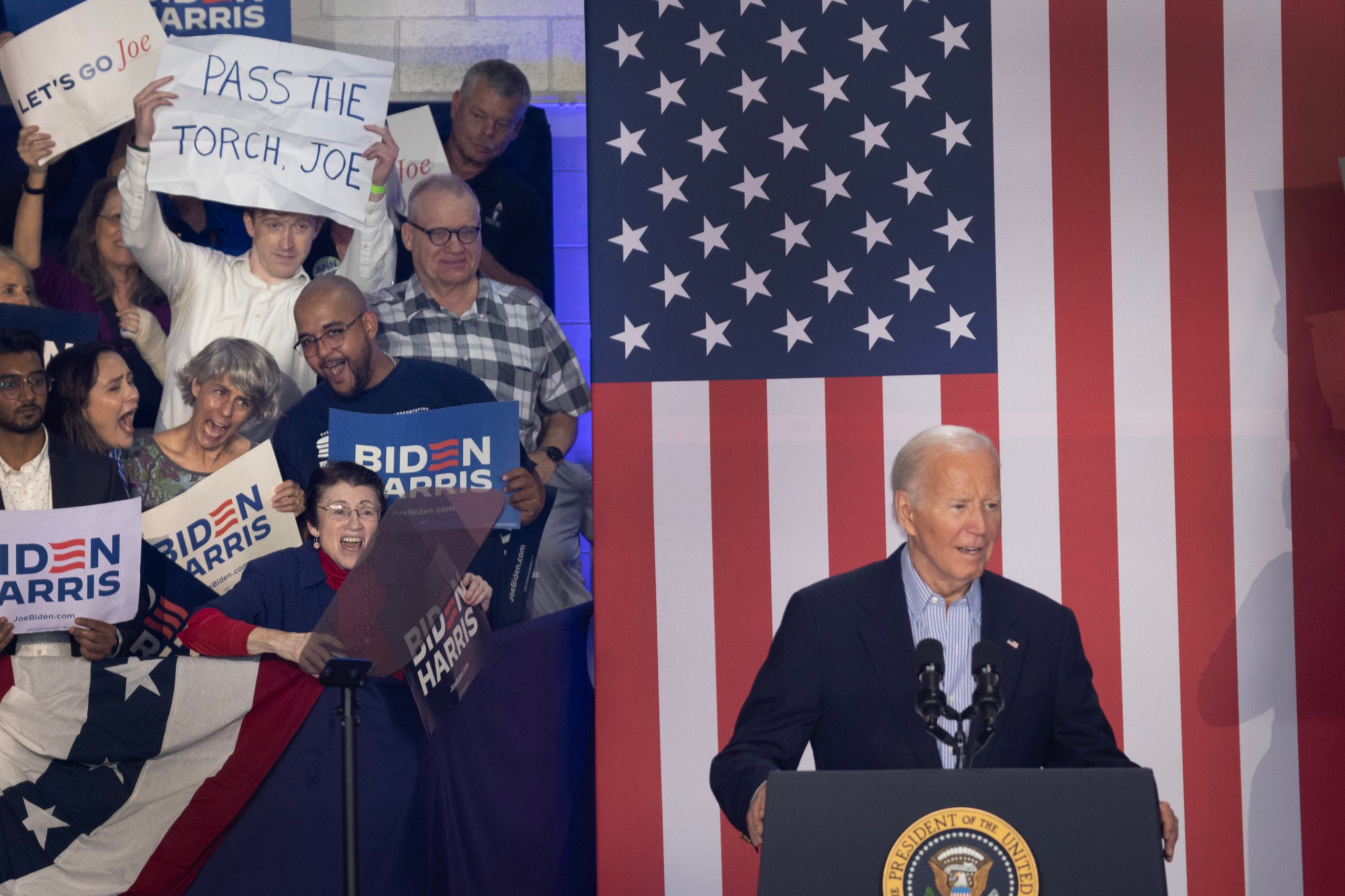 An audience member holds a sign calling on President Joe Biden to "pass the torch" during a campaign rally at Sherman Middle School on July 05, 2024 in Madison, Wisconsin. Biden has been receiving criticism suggesting that he is too old and in too poor health to serve another term as president. (Photo by Scott Olson/Getty Images)