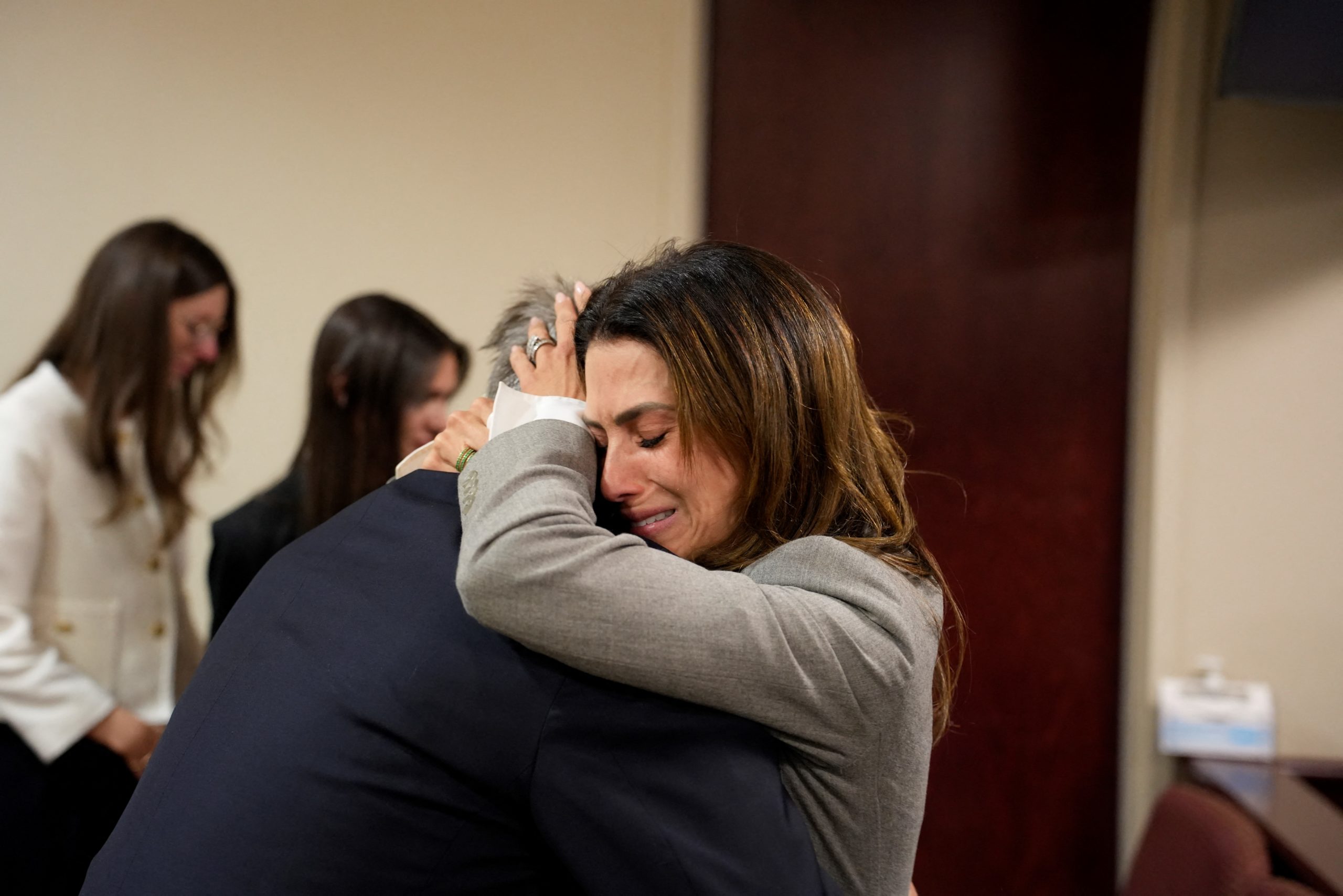 US actor Alec Baldwin and his wife Hilaria Baldwin embrace during his trial on involuntary manslaughter at Santa Fe County District Court in Santa Fe, New Mexico, on July 12, 2024. Baldwin's trial for involuntary manslaughter was dismissed by a judge Friday after she ruled that key evidence over a fatal shooting on the set of "Rust" had been withheld from the defense. (Photo by Ramsay de Give / POOL / AFP) (Photo by RAMSAY DE GIVE/POOL/AFP via Getty Images)