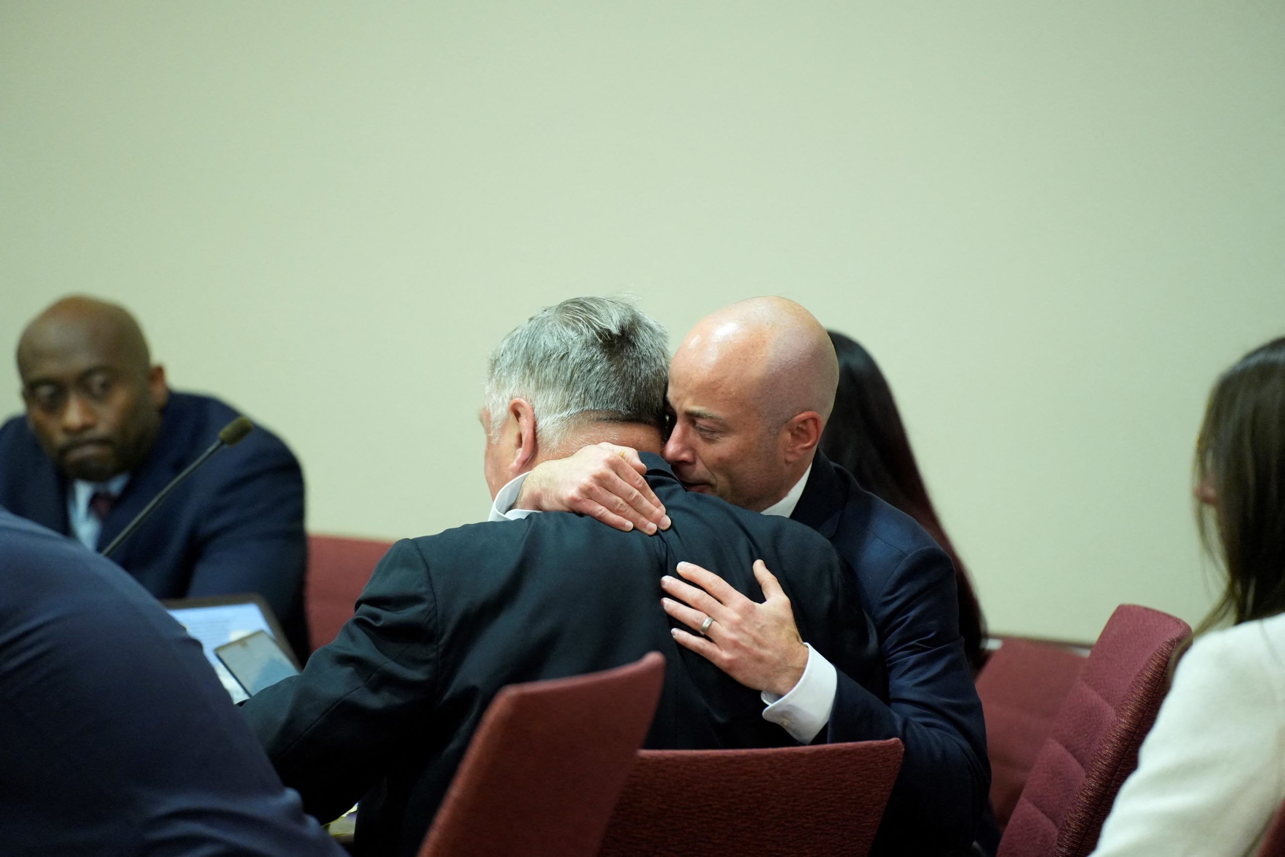 Attorney Luke Nikas embraces actor Alec Baldwin during his trial on involuntary manslaughter at Santa Fe County District Court in Santa Fe, New Mexico, on July 12, 2024. Baldwin's trial for involuntary manslaughter was dismissed by a judge Friday after she ruled that key evidence over a fatal shooting on the set of "Rust" had been withheld from the defense. (Photo by RAMSAY DE GIVE / POOL / AFP) (Photo by RAMSAY DE GIVE/POOL/AFP via Getty Images)